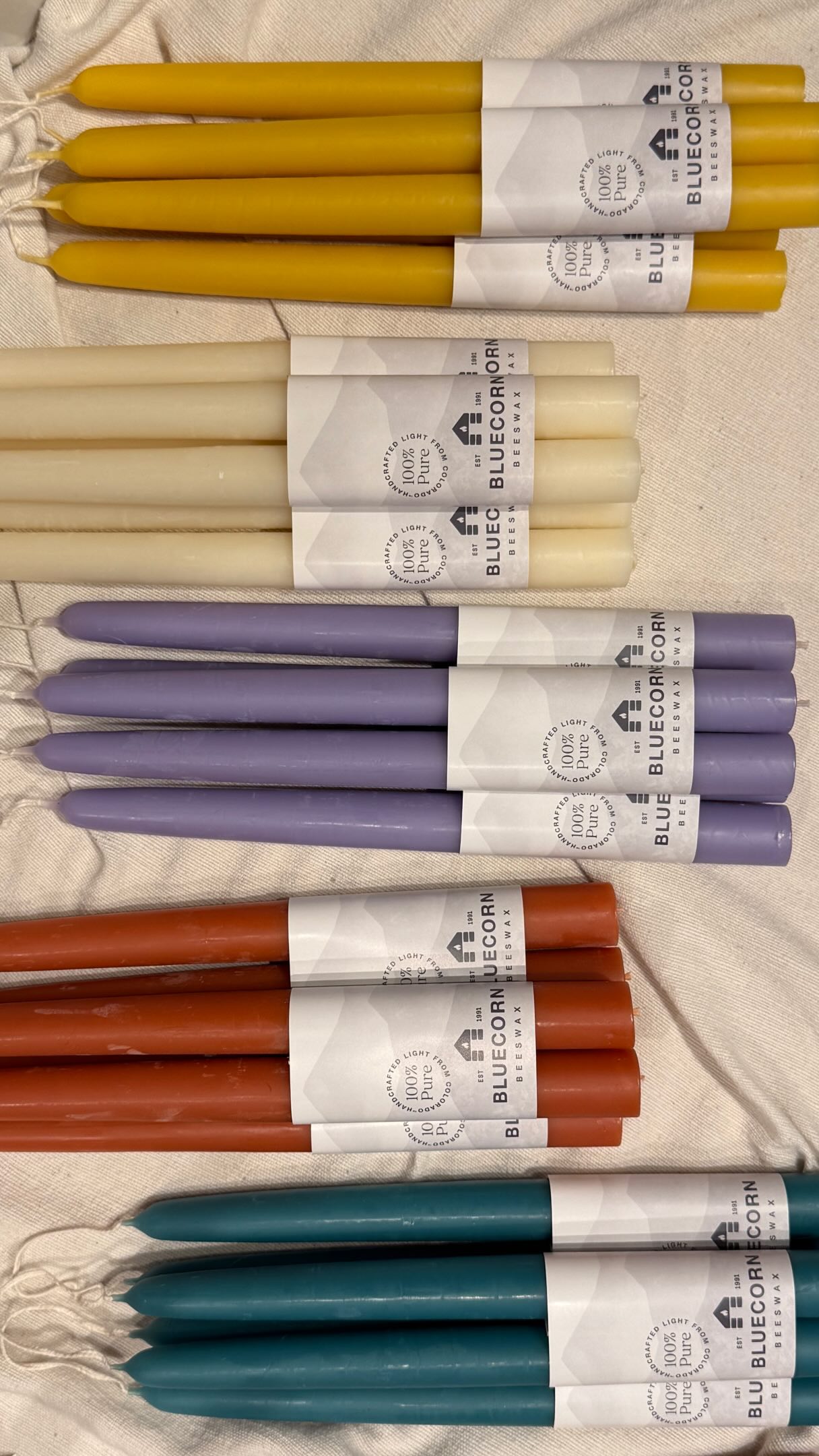 100% natural beeswax taper candles. Perfect for your table.
These beautiful candles carry the rich scent of honey, and will burn virtually dripless for about one hour per inch of length. Created with pure molten beeswax at just the right temperature by a steady artisan hand and a keen eye, they are dipped and cooled over twenty times, creating a high quality candle to accompany your everyday gatherings and special occasions.
#artisanmade #entertaining #shoplocal