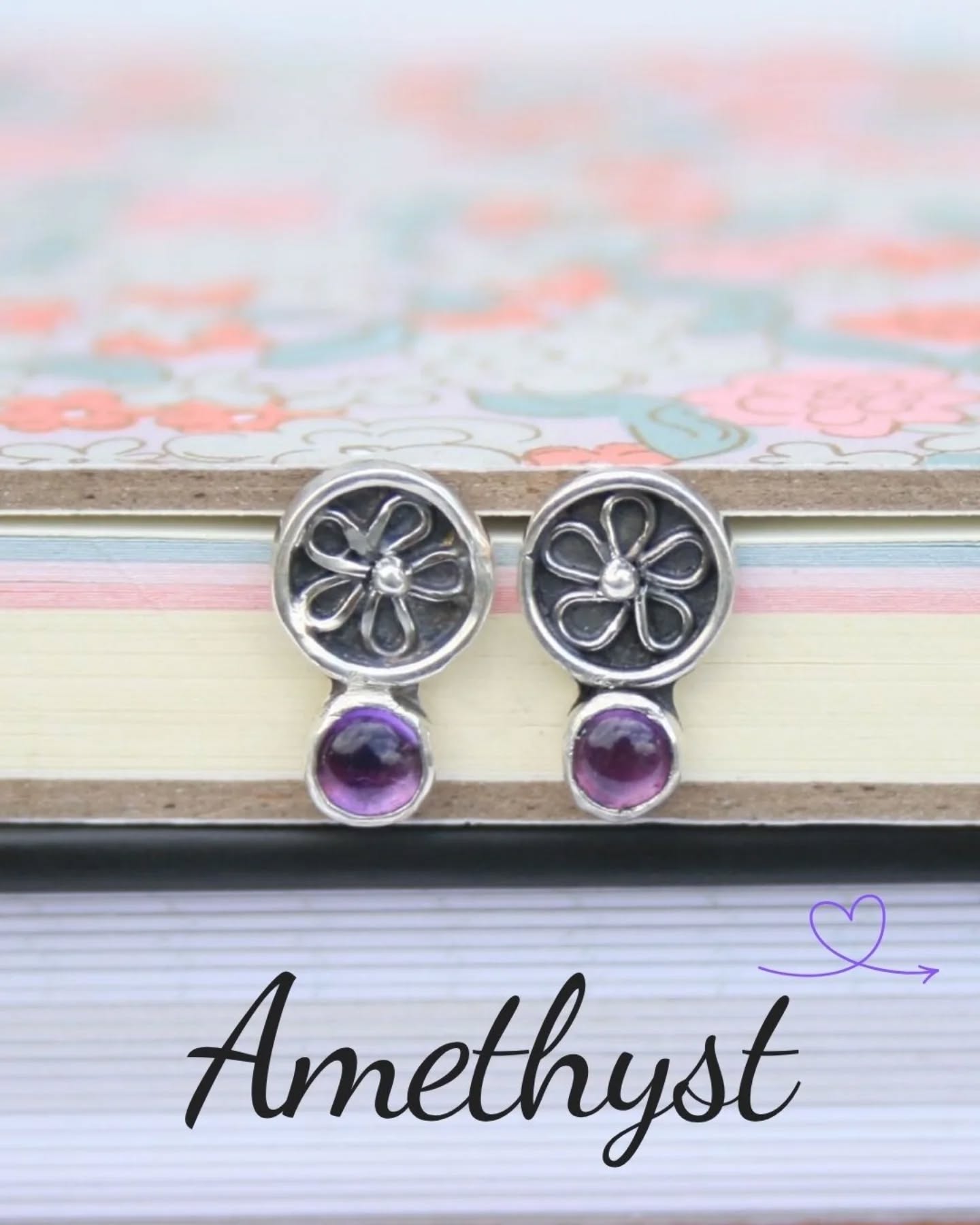 A few weeks ago I shared a photo of a single earring after I managed to lose its partner down the sink while rinsing it - right at the point they were ready for stone setting, which was more than a little frustrating!
I’ve now remade the missing piece and the stones are safely set. They’re such a dainty pair, measuring just 13 mm in length, and I love the little shadowbox detail with the silver flower sitting just beneath the amethysts.
They’re now available, so if you’re interested or have any questions, feel free to get in touch 😊