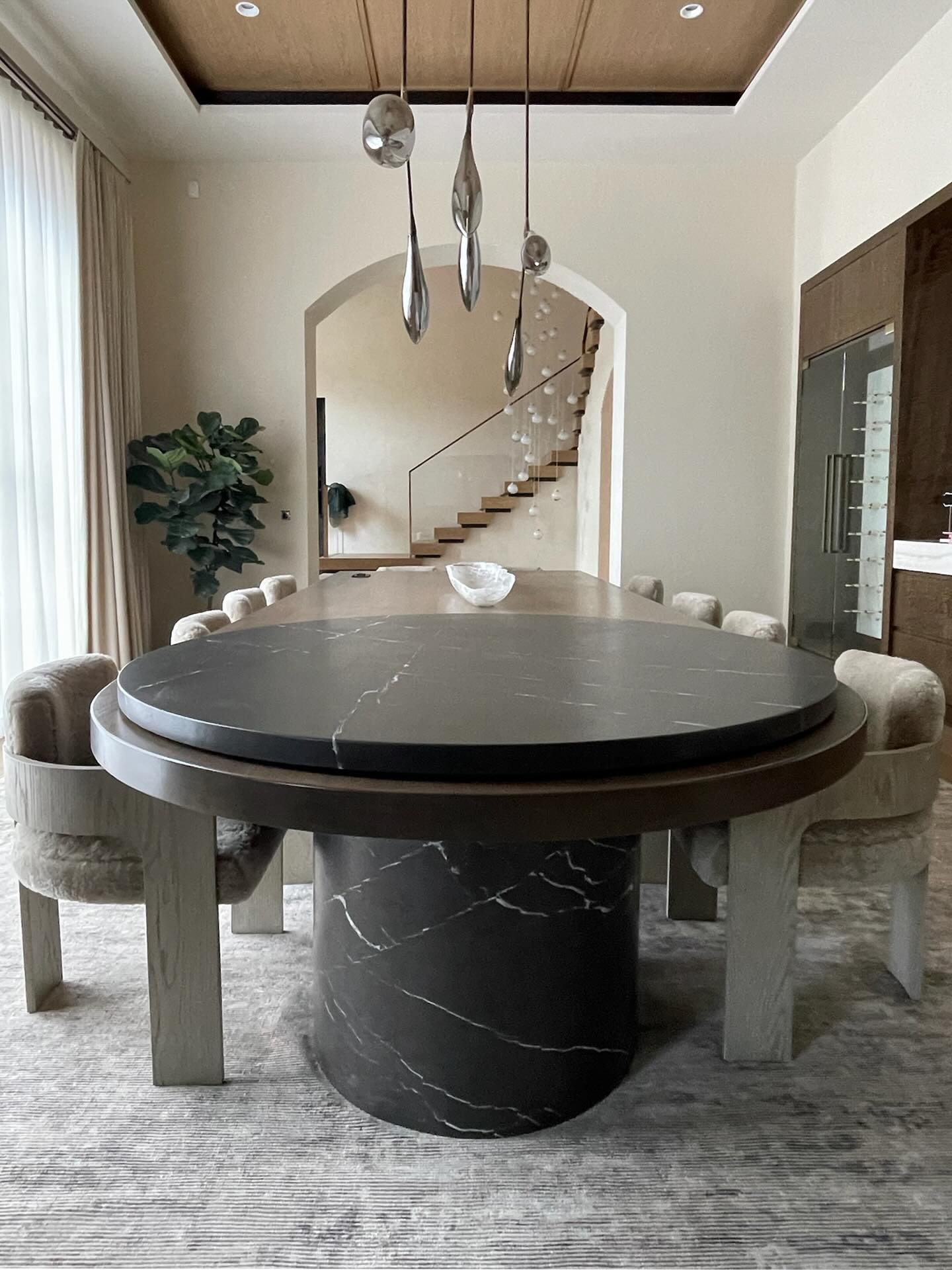 The best design has an element of surprise.
In the dining room of a recently-completed Central Pennsylvania estate, we created a large 52inch “lazy susan” designed to perfectly integrate with the wood and marble dining table below.
Entertaining is high on our clients priority list, so this feature allows guests to move freely around the open floor plan space and graze from the tabletop.
Zack crafted the rotating disk to sit 2 inches off the table edge with a seamless glide and hand painted it to match the black and white veining in the table base. The top is painted with a food safe, highly durable acrylic coating.
Designer: @glennastonedesign
Architect: @millanarchitects
Construction: @mccloskeybuilders