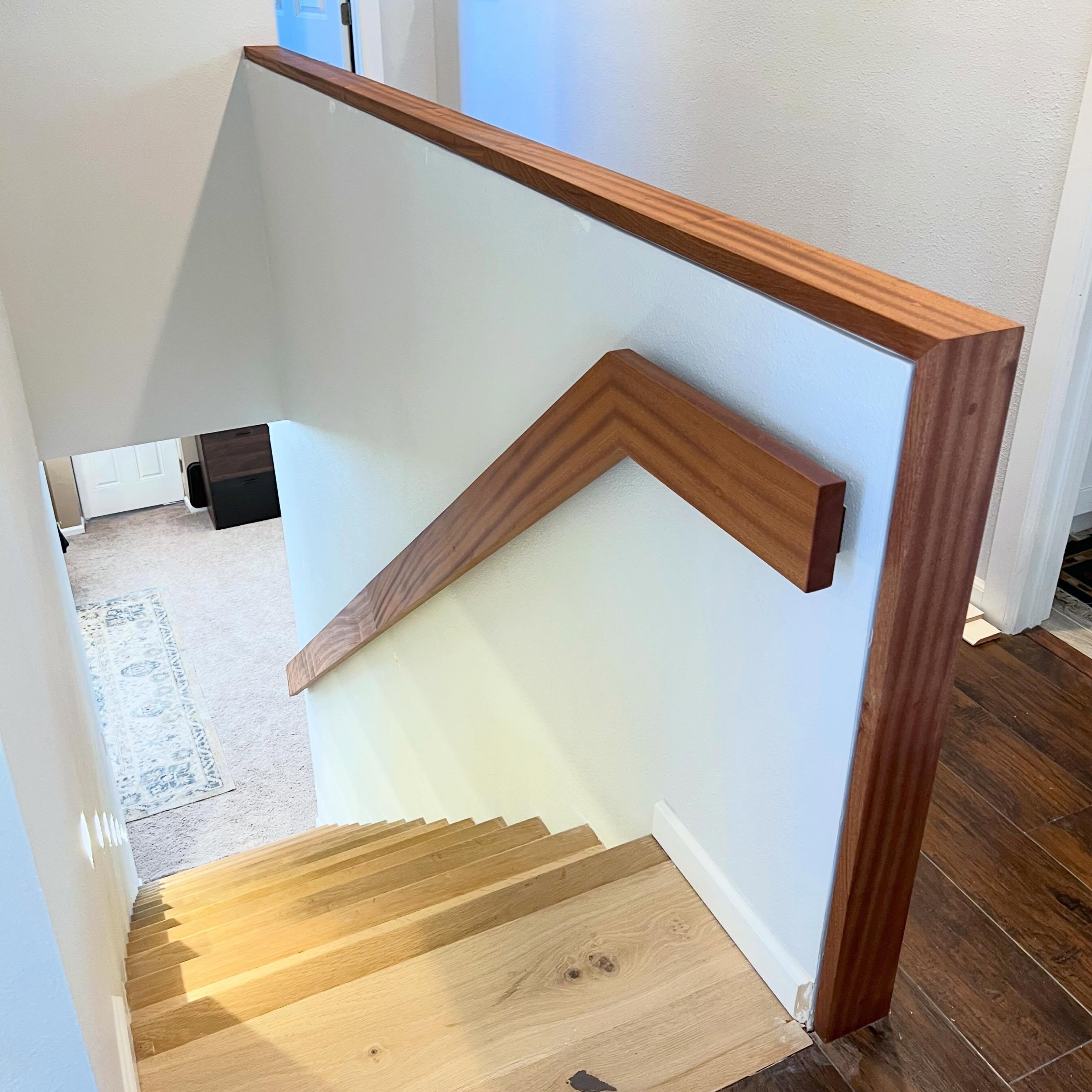 Ribbon sapele handrail and half wall waterfall railing. There is a nice 1/4” reveal in the half wall railing that doesn’t show in pics. But the grain is pretty!