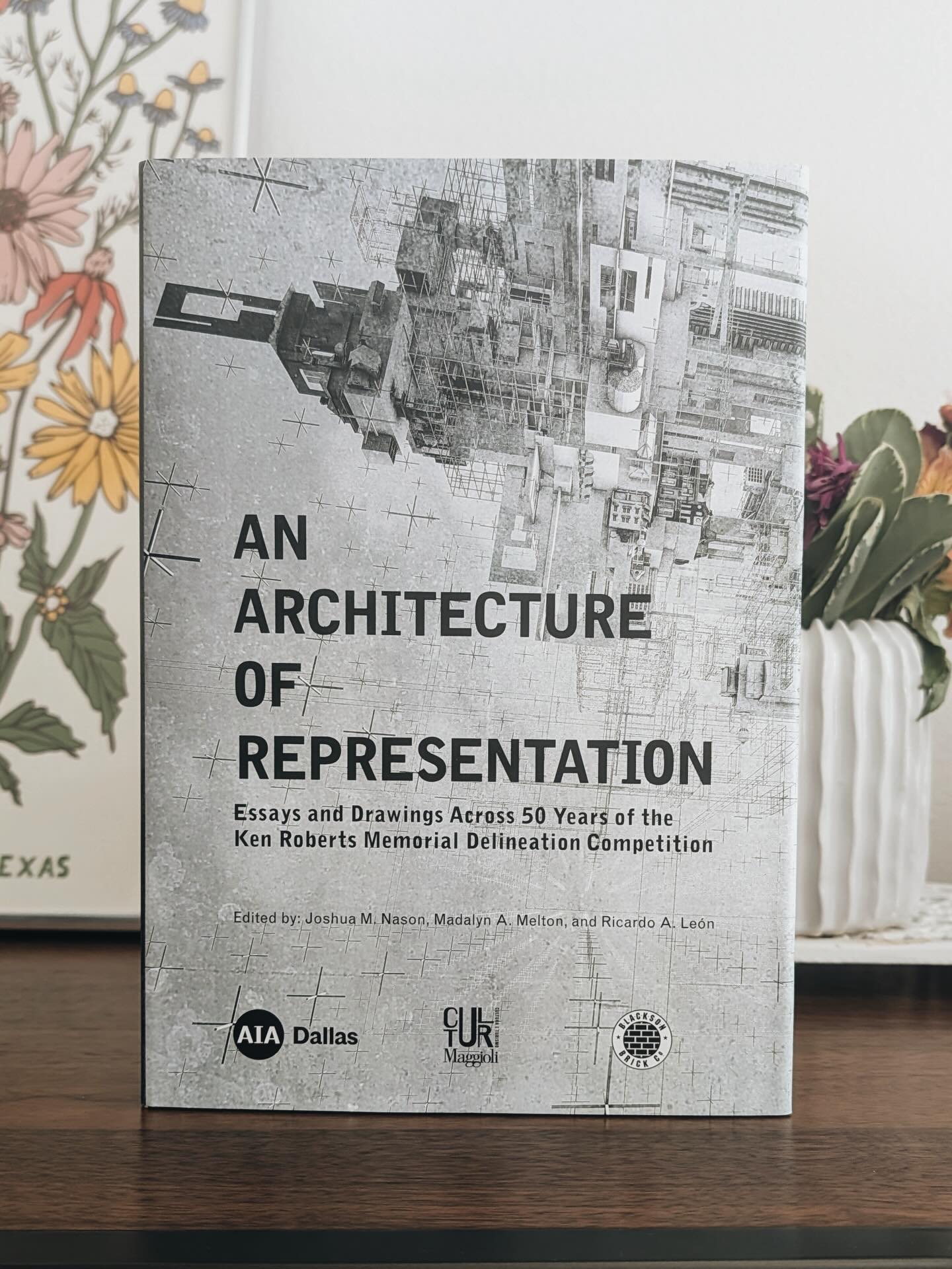 In the spirit of sharing our love of books, we are pleased to highlight a new book edited and designed by our very own, Ricardo A. León, titled “An Architecture of Representation: Essays and Drawings Across 50 Years of the Ken Roberts Memorial Delineation Competition.”
This book commemorates the 50th anniversary of the Ken Roberts Memorial Delineation Competition, known as KRob. It houses a collection of drawings gathered across 50 years and situates between them a series of writings on a range of related topics, from the history of the competition and key role players in its history to musings on the means, media, and roles of architectural representation.
Founded and hosted by the Dallas chapter of the American Institute of Architects, KRob has celebrated the best in architectural representation for over 50 years and is recognized internationally as the longest-running architectural drawing competition.
Get your copy today at the Architecture and Design Exchange in Dallas or by visiting the following link: https://www.dallasadex.org/programs/purchase-an-architecture-of-representation/