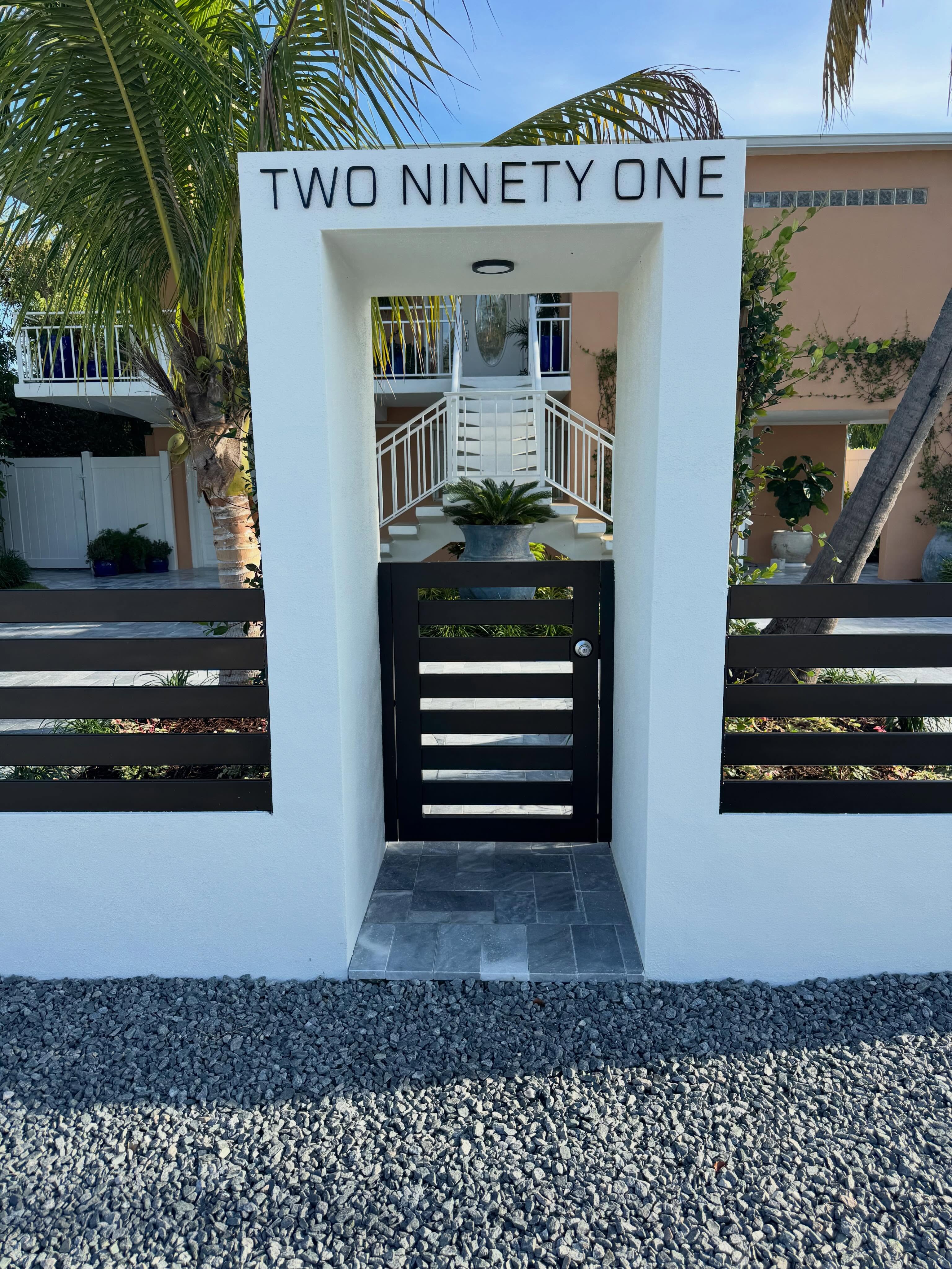 Aluminum rail on top of masonry wall with motorized roll gates and pedestrian gate. Color is a special order metallic bronze. Wall built by @buildwithmcf #aluminumfabrication #horizontalfence #customfence #knowafenceguy #knowafenceco