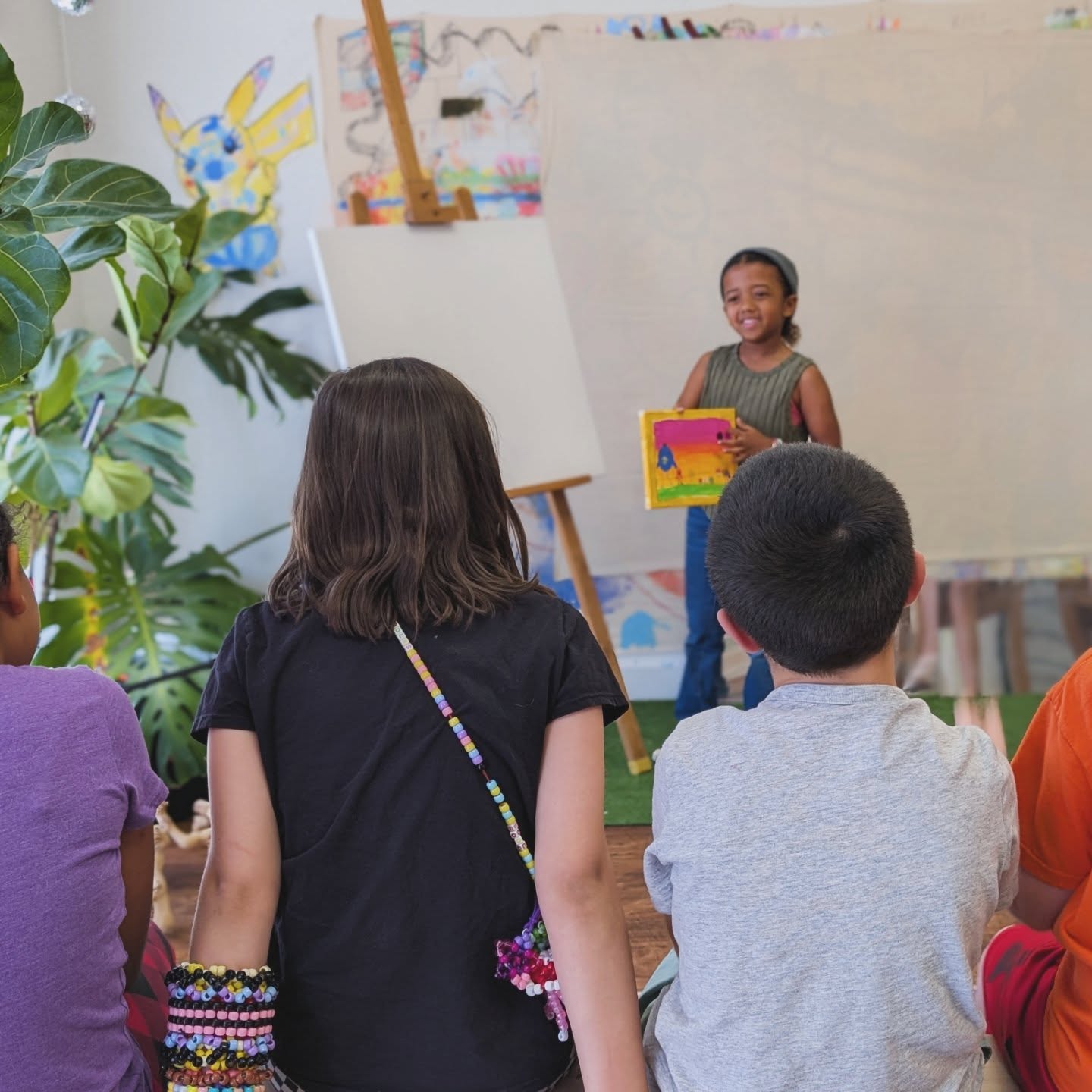 Each month, we wrap up with artist presentations. Students practice their public speaking by leading a discussion about their work: sharing their process, the mediums they used, what inspired them, and their favorite part of creating it.
They then open the floor to a short Q&A, where their peers ask the kind of imaginative, unexpected questions only kids can come up with. We end with a big round of applause, leaving each student with a boost of confidence and a strong sense of accomplishment.
It’s always inspiring to see how supportive everyone is of one another, and how this space continues to grow into a community rooted in art, friendship, and learning.