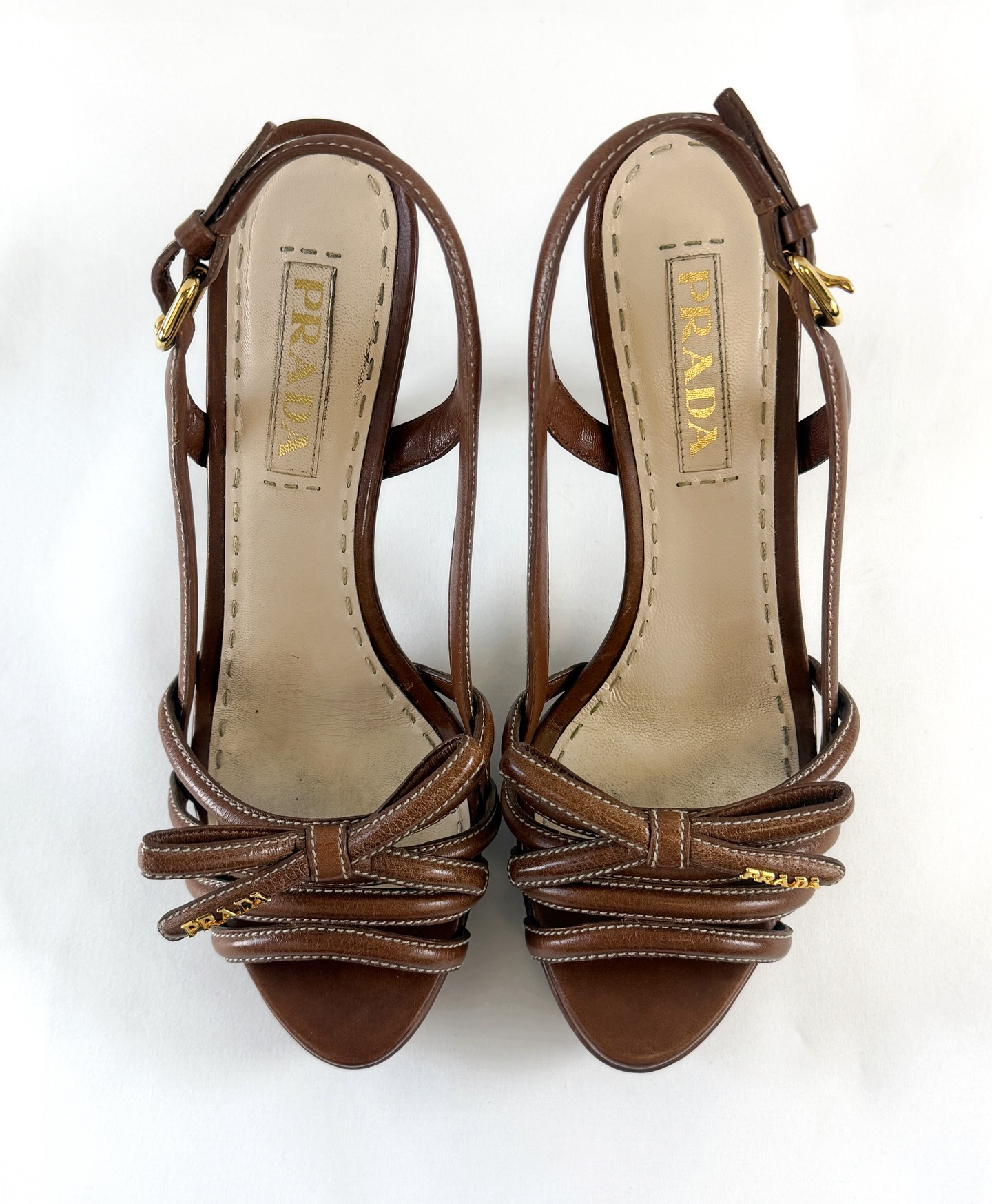 Prada brown leather bow sandals in size 37.5. DM for more details. #prada #vintage #designer #bellissimaconsignmentboutique