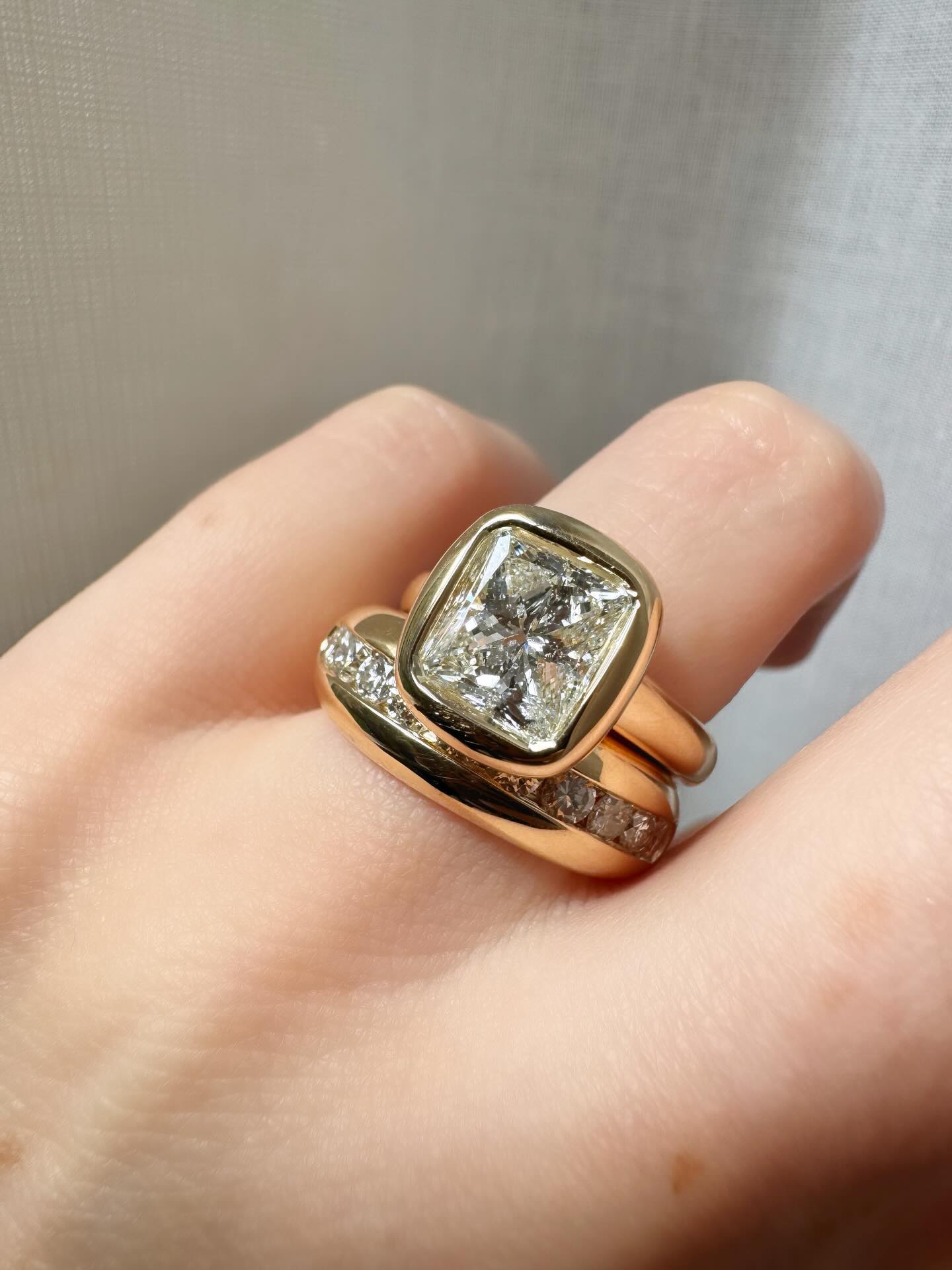 Recent reset for a client, from a white gold halo setting to a pillowy yellow gold solitaire with chubby stacker ✨