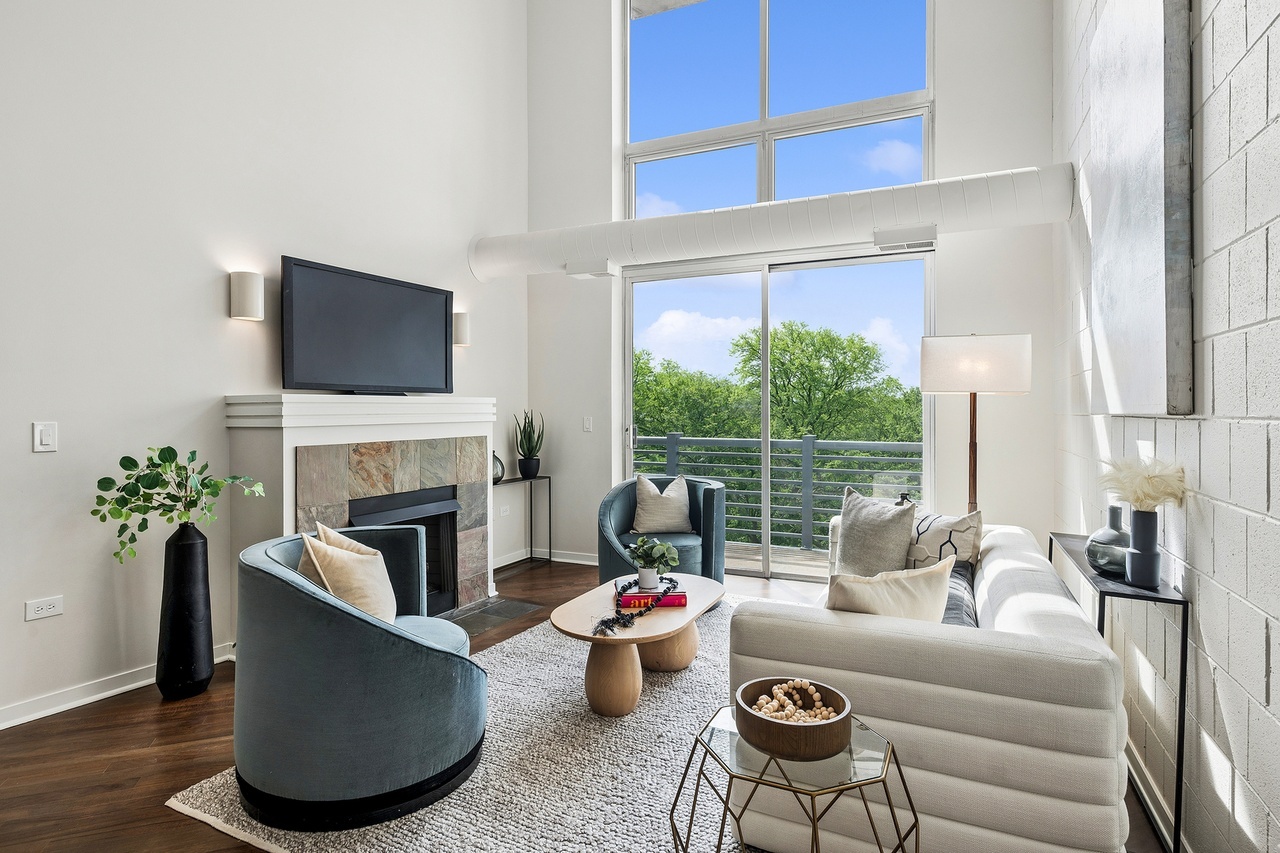 Loving these two-story windows and soaring ceilings! We added rounded silhouettes and cozy textures to warm the space up. It all works together to show a chic and unique space! #chicago #chicagorealestate #havenhomestager #chicagohomestaging #stagingworks #stagingsells #staging #homestaging