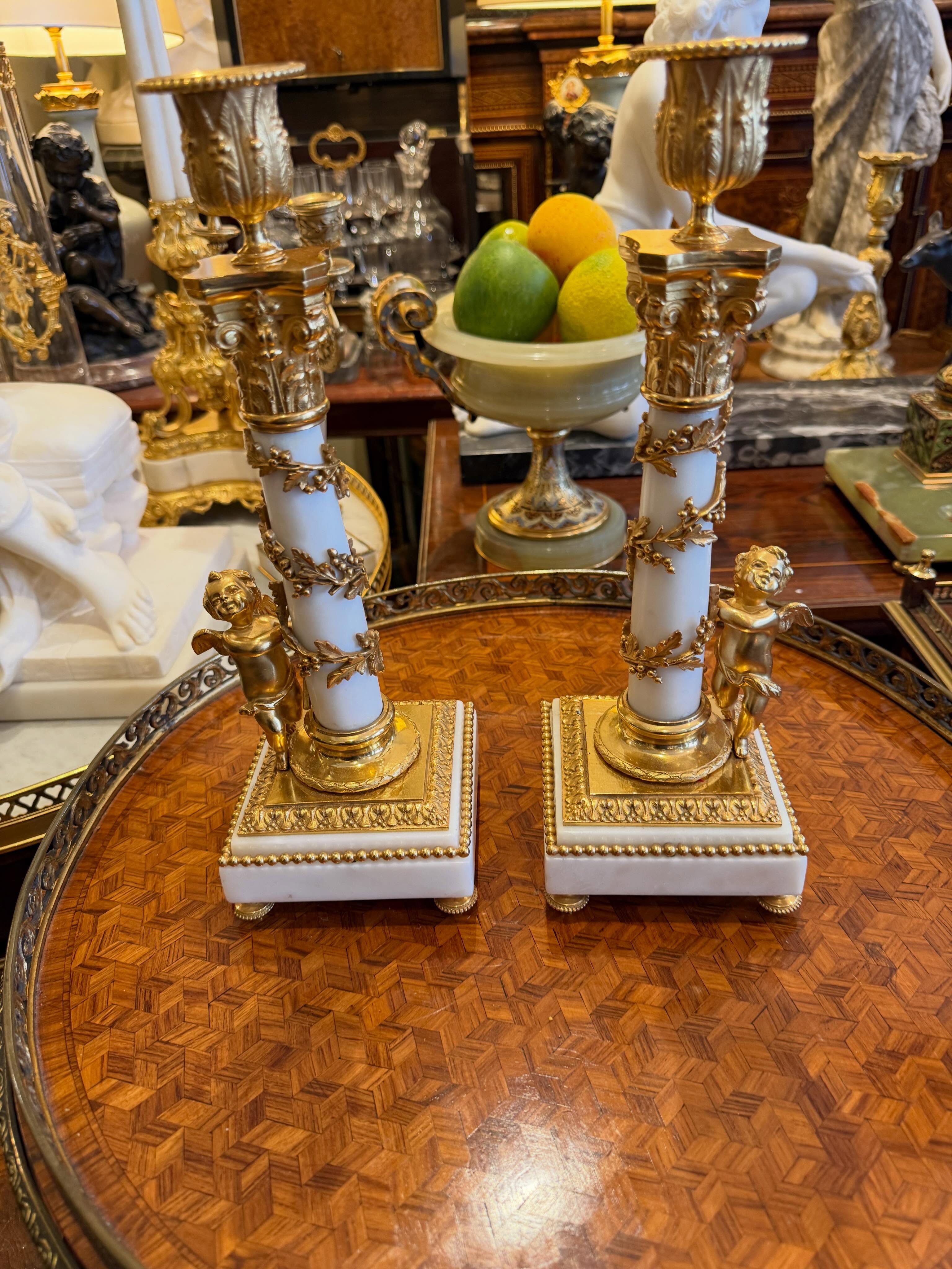 Pair of whitemarble/gilt bronze candlesticks#french#antique#objet d’art#cherubs#portobello furniture warehouse