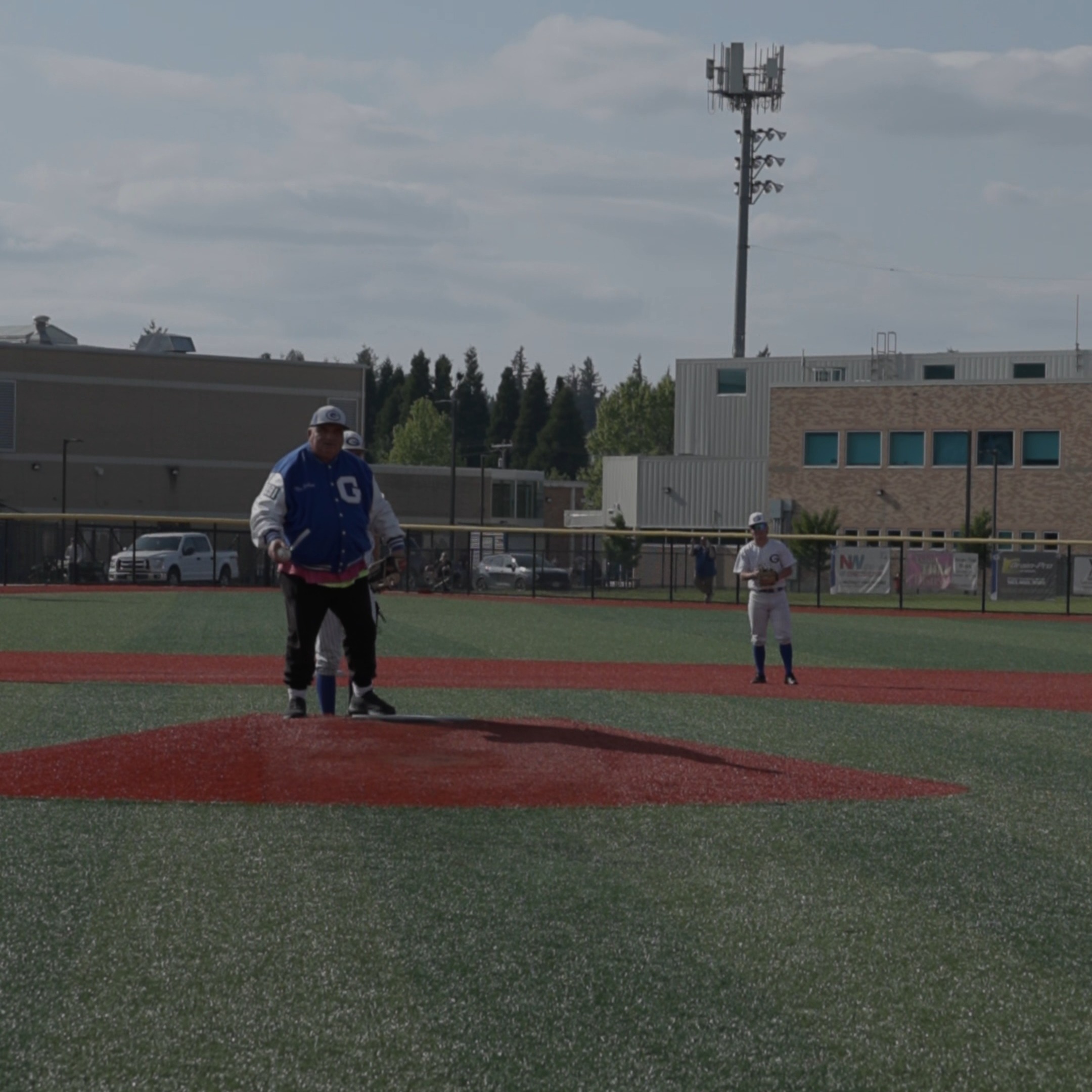 Mr. Gresham throwing out the first pitch for the baseball team's senior night.