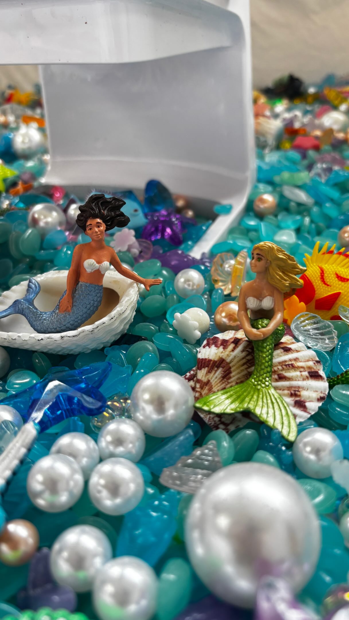 🧜♀️ #MERMAY sensory bin! Watch as we build an ocean of treasure and delight for our kiddos 🥰🧜♀️🐚🪼🪸 We actually reused a lot of the filler from our coral reef sensory bin for this one. If you’re interested, comment “MERMAY” and I’ll DM you the links to what we added to make this mermaid treasure trove 🪸🧜♀️💞 #sensorybin #mermaid #prek #sensory