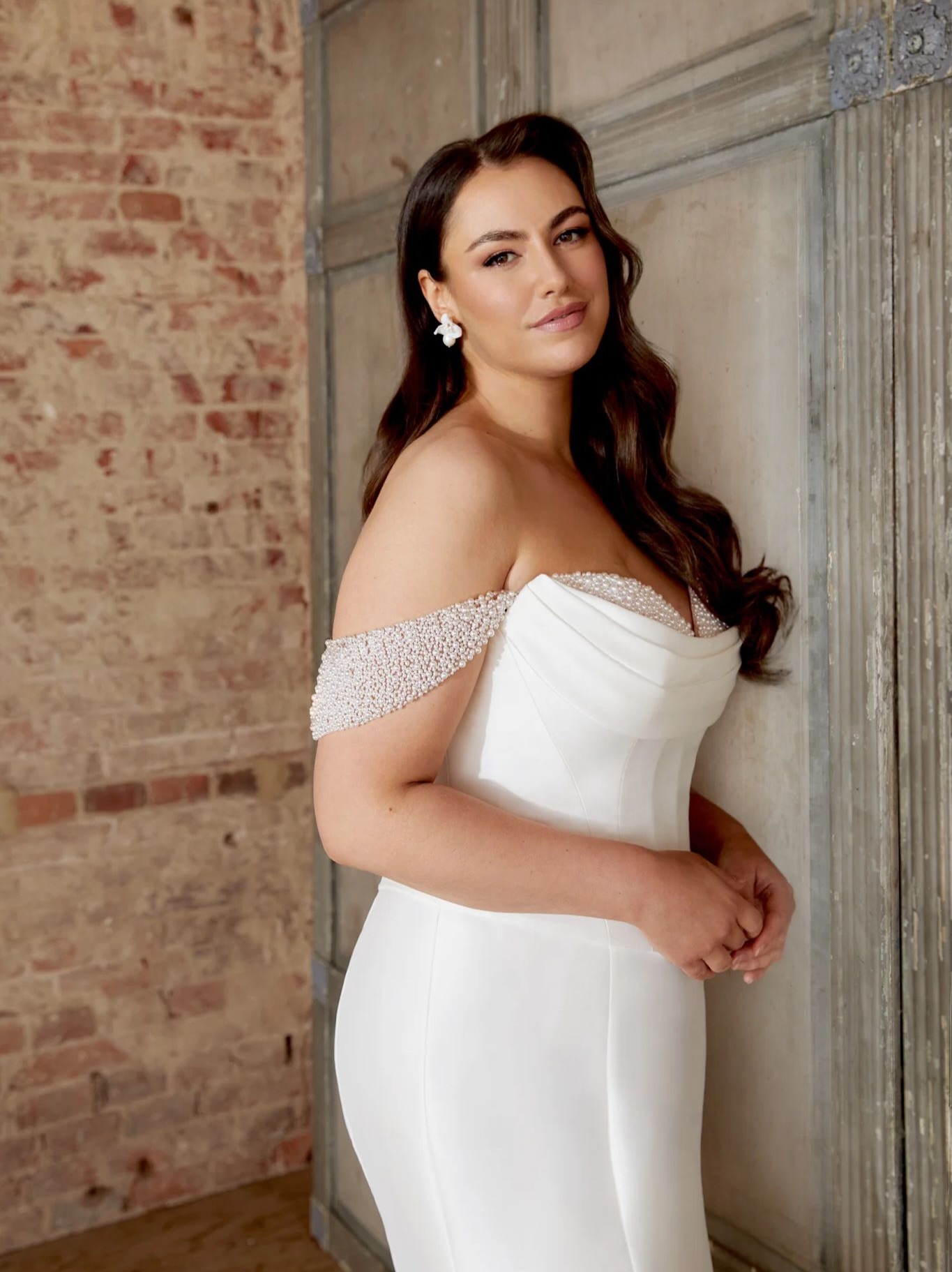 Minimalist elegance at its finest ✨
This stunning Sincerity gown features a sculpted corset bodice with soft draping across the neckline and delicate off-the-shoulder pearl straps for a timeless romantic feel. Crafted in sleek crepe, the fitted silhouette hugs in all the right places before flowing into a dramatic flared train for the perfect bridal statement 🤍