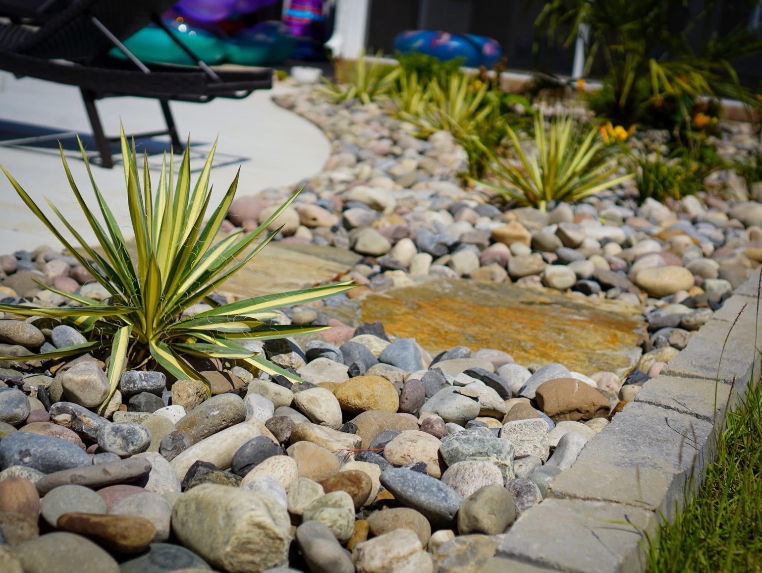 Our New England River Rock looks stunning with any color palette. Whether used as edging or as an accent in any landscaping design, it truly shines and adds timeless natural beauty to every outdoor space.