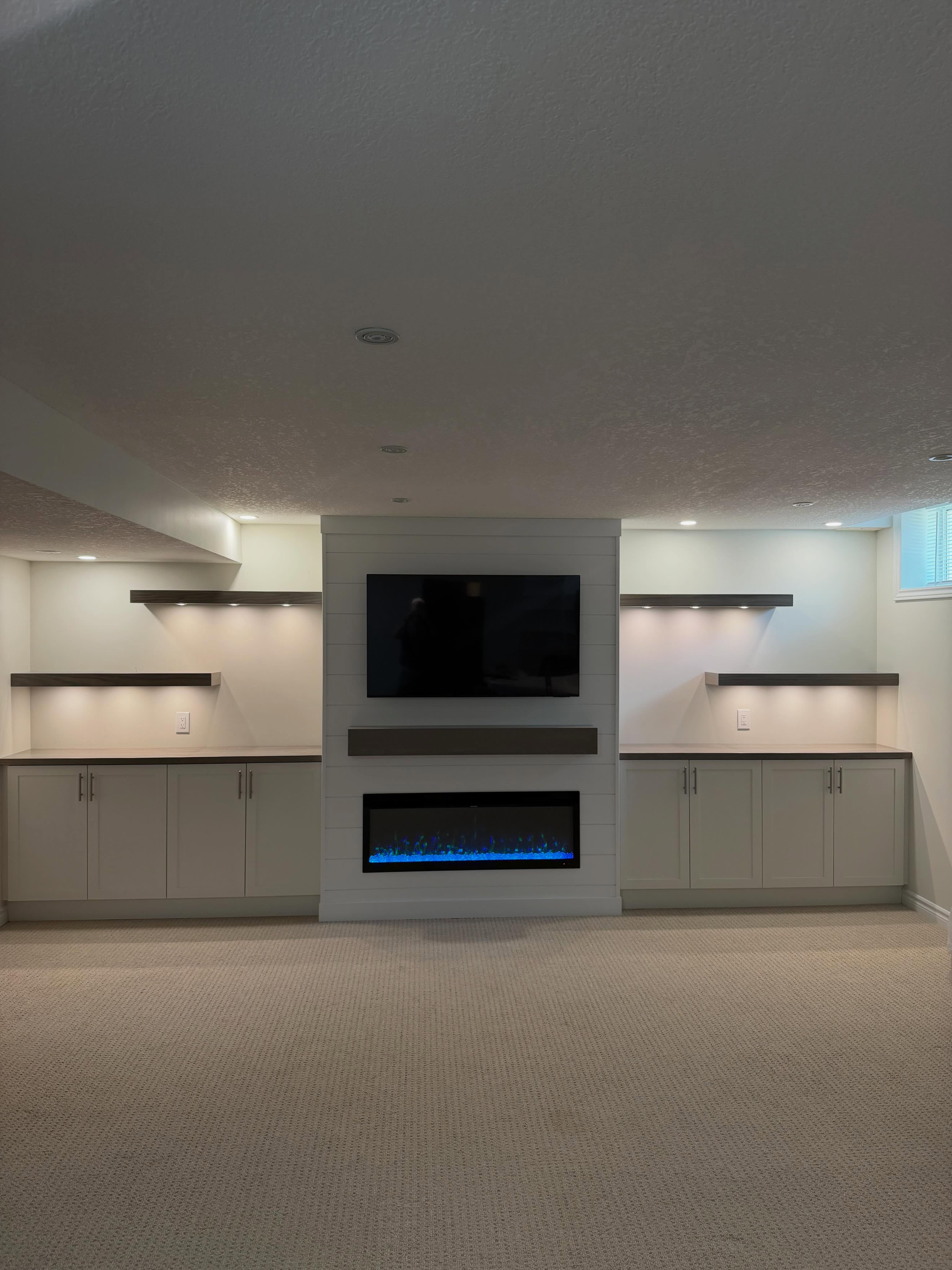 This project turned out absolutely amazing from start to finish! 🔥
Not only did we create this stunning custom fireplace built-in unit, but we completely transformed the entire space around it. We removed outdated closets, re-drywalled the wall, and designed multiple-depth cabinetry to give the room a clean, elegant, custom look that truly stands out.
To maximize storage throughout the home, we also added a beautiful bookshelf and a custom cabinet in our client’s utility room — proving that functional spaces can still look incredible.
This fireplace feature became the true focal point of the home with custom shiplap detailing, floating shelves, LED multi-white lighting with Bluetooth switches, new pot lights, and all the finishing touches to bring the space together perfectly. We supplied everything for this project to make the process easy and stress-free for our clients.
A huge thank you to Anderson Home Improvements for helping us bring this vision to life and doing an amazing job along the way.
Our clients couldn’t be happier with the final outcome, and honestly, neither could we. Projects like this are why we love what we do.
If you’re thinking about adding a custom fireplace built-in unit to your home and creating a beautiful focal point that adds both value and style, contact Dubes Custom Creations today for an in-home consultation! Dubescustomcreations@gmail.com Www.dubescustomcreations.ca