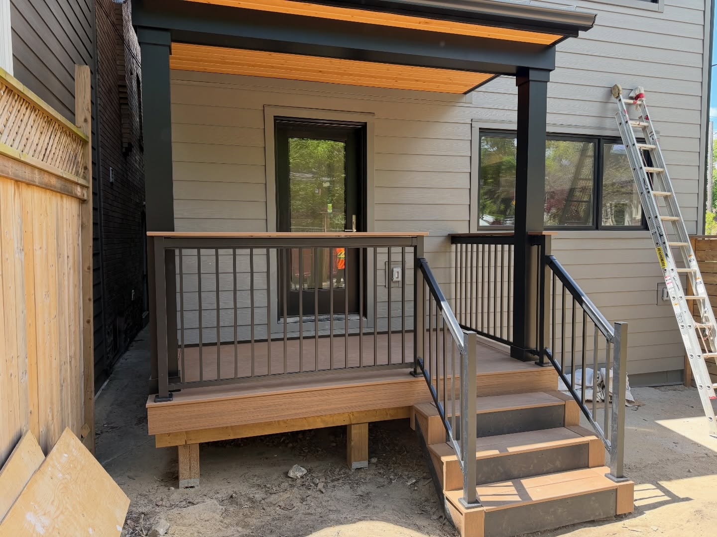 Front and back porch upgrades making a big difference on this Toronto home. Regal drink rails paired with Trex Lineage Jasper boards really make these spaces pop. Once the skirting and final clean-up are completed, the exterior will be move-in ready alongside the freshly renovated interiors. #trexdecking #regalrailing #compositedecking #durhamregionhomes #deckresurfacing