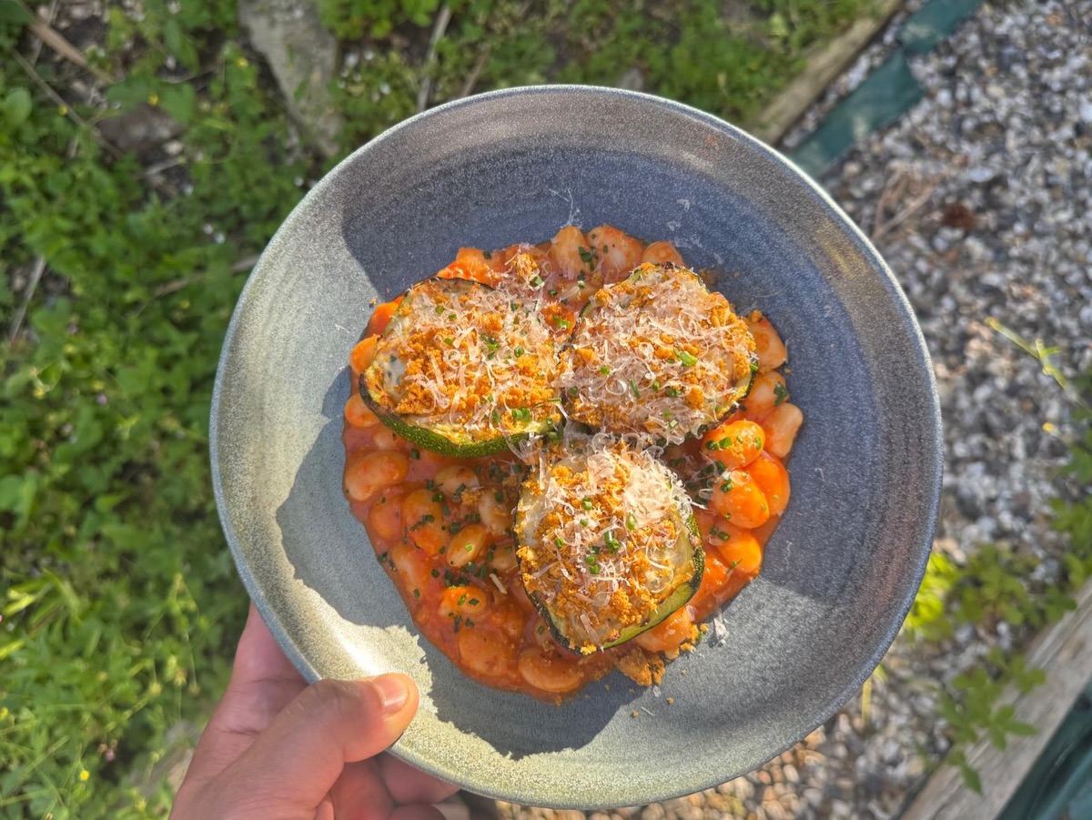 Stuffed French Courgette with romesco sauce, butterbeans, ricotta and smoked almond crumb