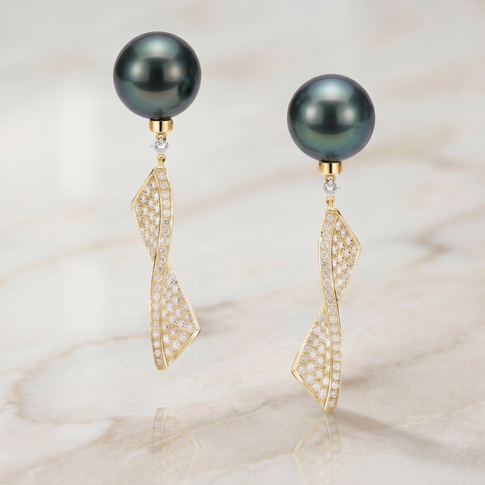 Midas Jewellery Bondi
Elevate your ensemble with Midas Jewellery’s mesmerising Black Tahitian Pearl and Diamond Ribbon Drop Earrings. These striking earrings showcase rare, deep hued pearls, set against a flowing ribbon design encrusted with scintillating white diamonds. The intricate design creates a sense of movement and grace, making these earrings a true statement piece. Perfectly blending modern elegance with timeless sophistication, they are the ultimate accessory for those who appreciate luxury and fine craftsmanship.
Details
Gemstone: Natural Diamond, Black Tahitian Pearl
Shape: Round Brilliant Cut
Diamond Quantity: 140
Total Diamond Weight: 1.85ct
Type: Tahitian Pearl Drop Earrings
Origin: Handmade in Australia
Additional Information
Other sizes and custom options available on request.