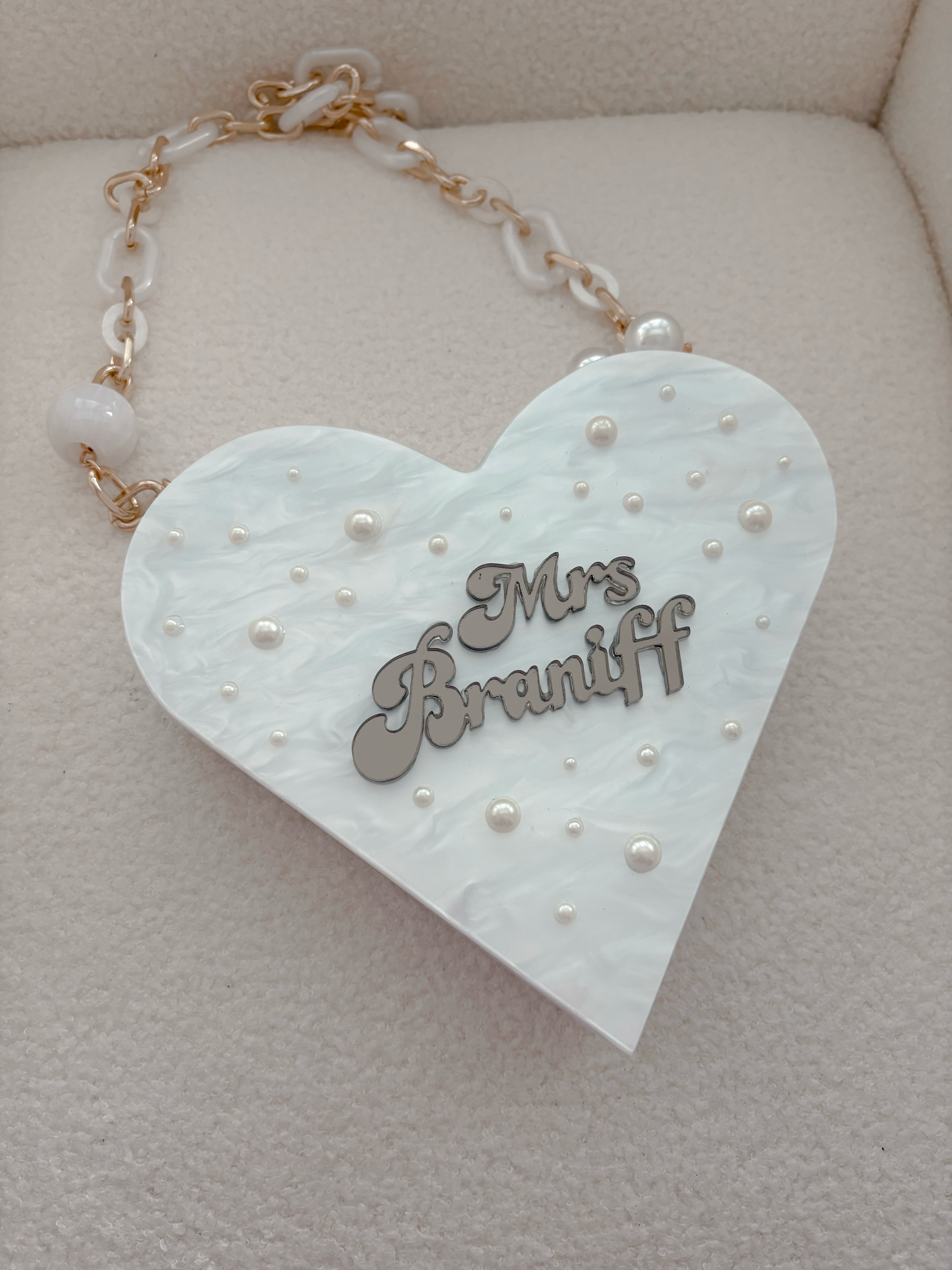 ✨ NEW ARRIVAL ✨
Our Personalised White Marble Heart Bag Charm is here! 🤍
Featuring a dreamy marble finish, delicate pearl accents, and your chosen name, it’s the perfect personalised accessory for brides, bridesmaids, and gifting🥰