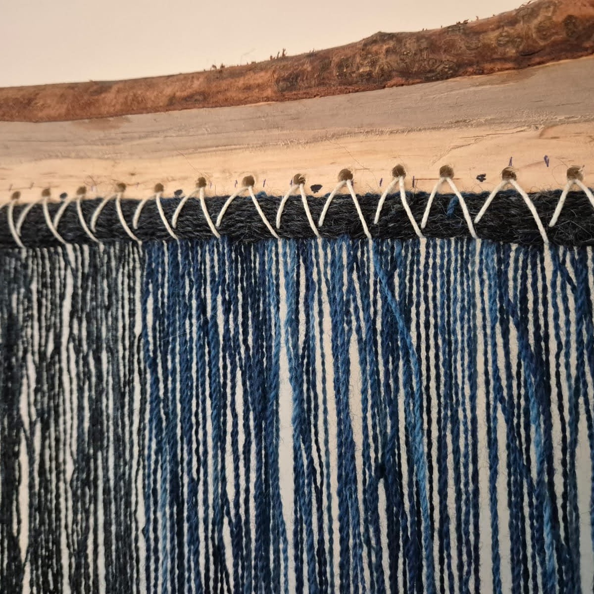 I am starting work on my next #vararfeldrexhibition piece: a beautiful blue cloak, based on a remarkable find from Estonia. The archaeological remnants show a 1cm wide braided strip sewn into the selvedge, so I have been working to replicate this with the beautiful indigo dyed wool used to weave the cloak.
#weaver #handwoven #vikingweaving #vikingcloak #vararfeldr #vikingreenactment #vikingcraft #heritagecraft
