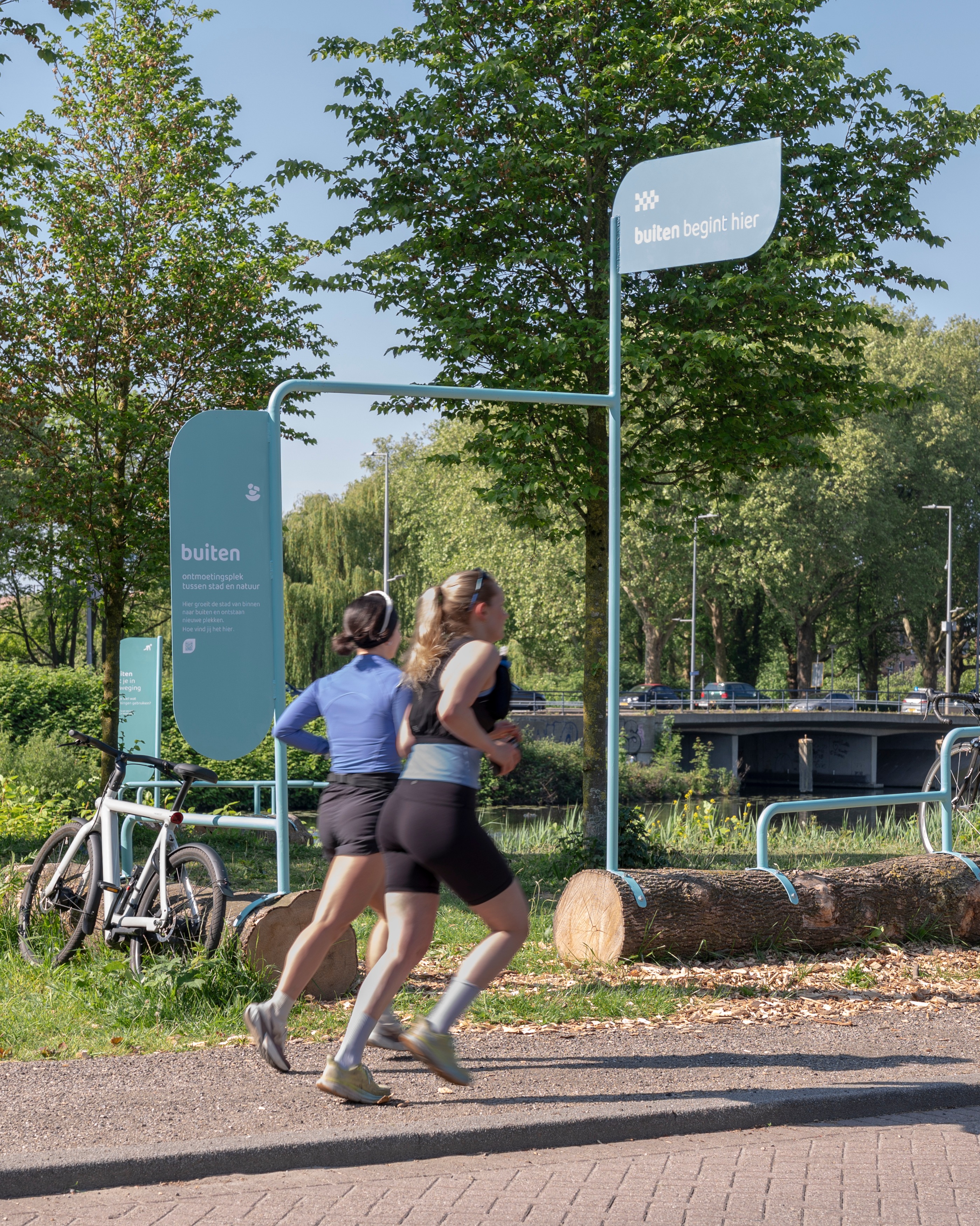 How do you activate a place at the edge of the city by making its undiscovered qualities visible?
Together with @aanpact , we have collaborated with @gemeenterotterdam to revitalise a patch of green in Rotterdam-Crooswijk on the side of the Rotte river.
Within the Municipality’s plan to redevelop the wider #PoortVanNoord area, we developed a temporary, low-cost tactical urbanism intervention to test how this liminal space at the edge of the city could actually work. Placemaking to explore, on the ground, how an infrastructure-heavy edge could become a green, social place that brings the neighbourhood back to the water.
The intervention features a starting point with a bike-repair station, social seating, a stretch-and-warm-up spot, and a lookout that frames the city against the open landscape. Each one is a small hypothesis about what the Veilingweg could be. Who stops, who lingers, who walks past. The project also features an online questionnaire – a simple landing page to capture the routes, favourite spots, hidden gems, barriers and mobility routines of people along the Rotte.
The project is a first pilot testing of a longer process of engagement with the area, in order to understand what permanent changes #PoortVanNoord is calling for. Throughout 2026, the intervention will also be activated with diverse open activities on-site.
Want to read more? Head to our website!
📸 by Loes van Duijvendijk