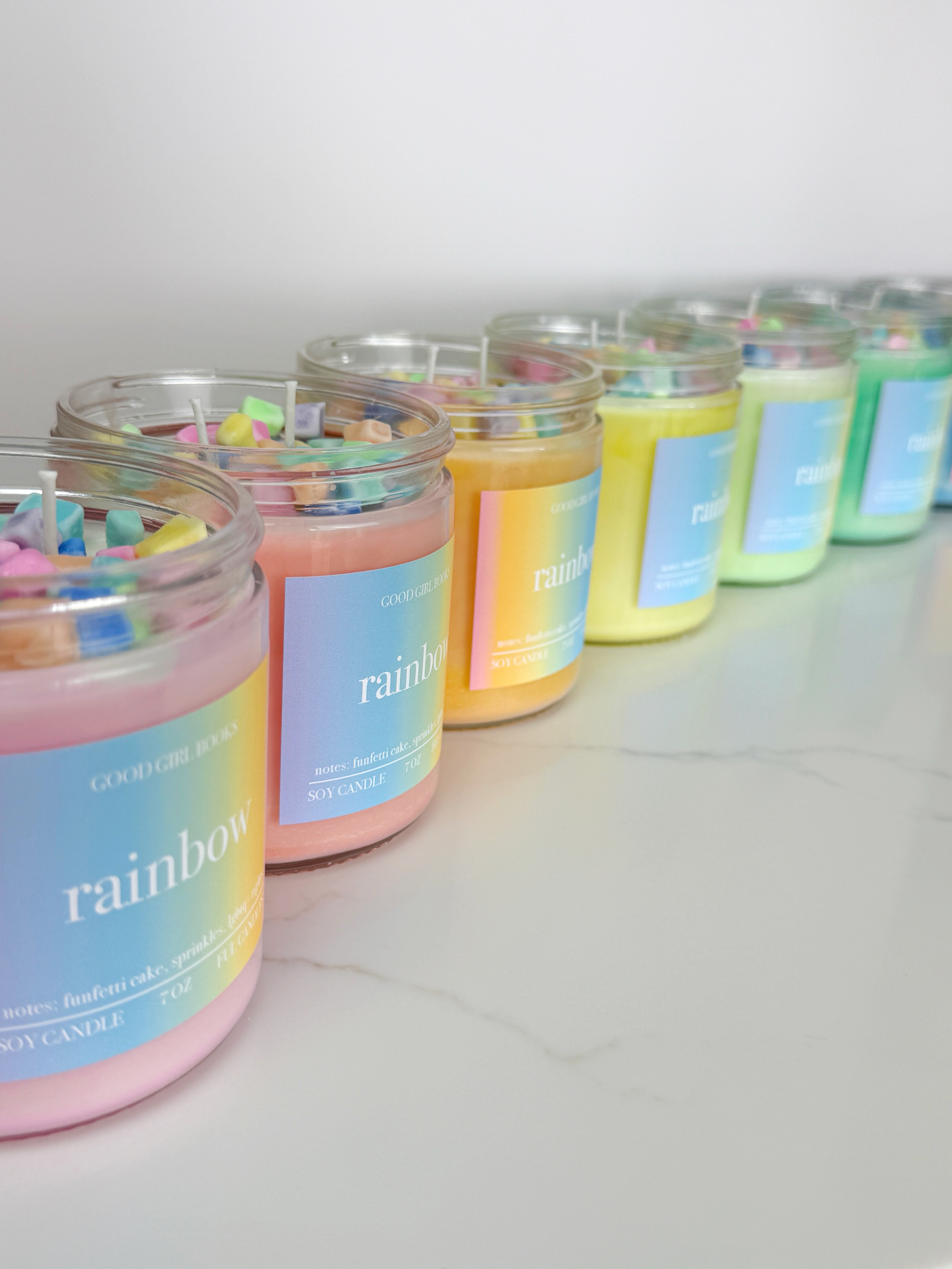 Our latest collab with @goodgirlbooksknox is here just in time for pride month!!! If funfetti cake and sprinkles and unicorns and rainbows were a candle, it would be this!!!! Making these was such a labor of love. From swirling each individual container so every color turned out unique, hand cutting the “sprinkles,” to designing the labels, this has been a lot of work, but one of my favorite projects to date. I hope y’all love it. 🧁