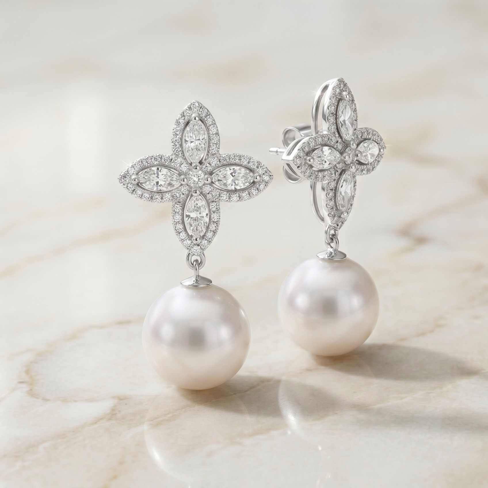 Midas Jewellery Bondi
A true celebration of luxury, these earrings feature radiant Australian South Sea Pearls suspended from a striking marquise diamond cluster. The floral inspired design, crafted with meticulously cut marquise diamonds in a pavé setting, adds a touch of opulence to the classic drop style. Perfect for those who seek timeless elegance with a modern twist.
Details
Gemstone: Natural Diamond, Pearlure Australian South Sea Pearls
Shape: Marquise Cut, Round Brilliant Cut
Pearl Quantity: 2 South Sea Pearl
Pearl Size: 12-12.5 mm
Diamond Quantity: 8 Marquise Cut
Total Weight: 0.50 Ct
Diamond Quantity: 106 Round Cut
Total Weight: 0.33 Ct
Type: Pearl Drop Earrings
Origin: Handmade in Australia
Additional Information
Other sizes and custom options available on request.