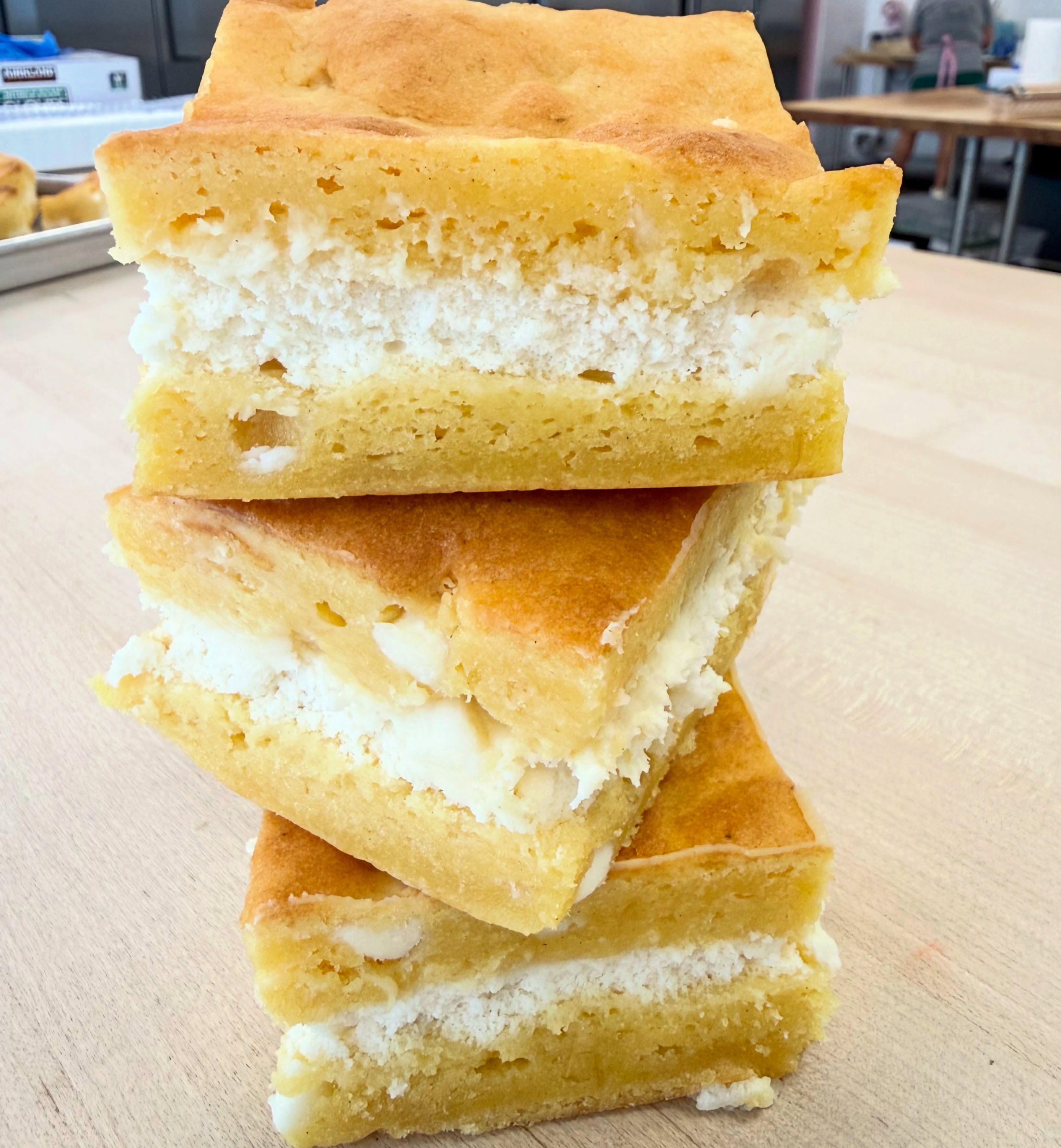 Looking for something sweet AND fruity?
One of today’s featured desserts is our LEMON 🍋 CHEESECAKE GOOEY BARS!
These decadent bars are layered with our luscious lemon white chocolate gooey base and topped with a rich vanilla cheesecake filling. Every bite is packed with creamy lemon flavor and sweet white chocolate goodness! 💛
They’re fresh in the showcase and ready for you to grab while supplies last!