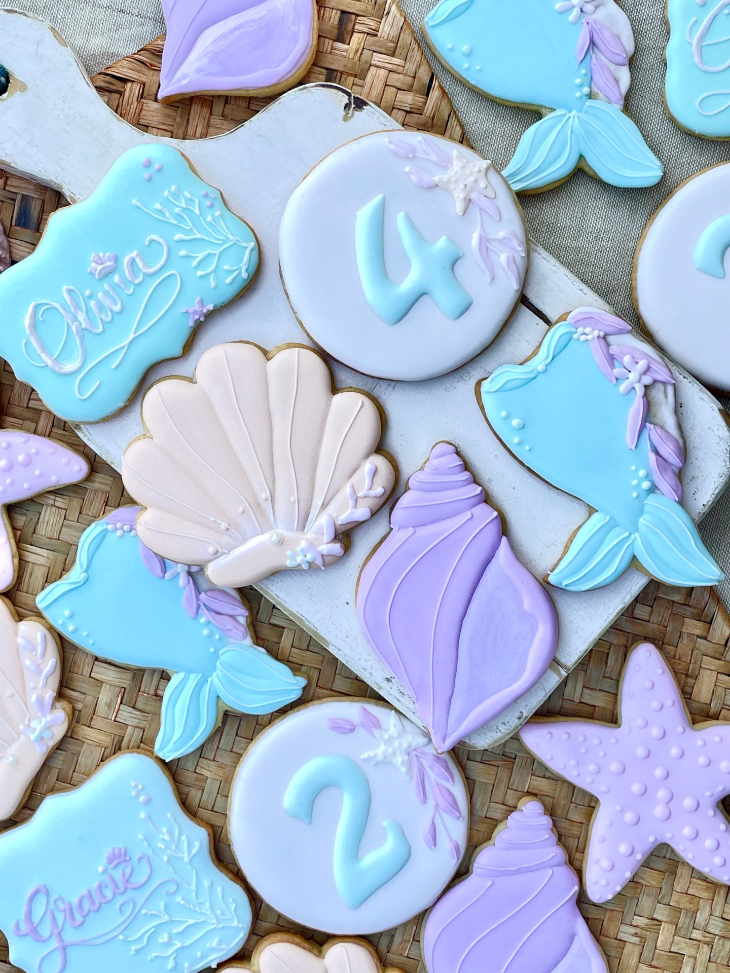 Pastel mermaid theme cookies with pretty sea shells. A perfect theme for sisters sharing a birthday party.