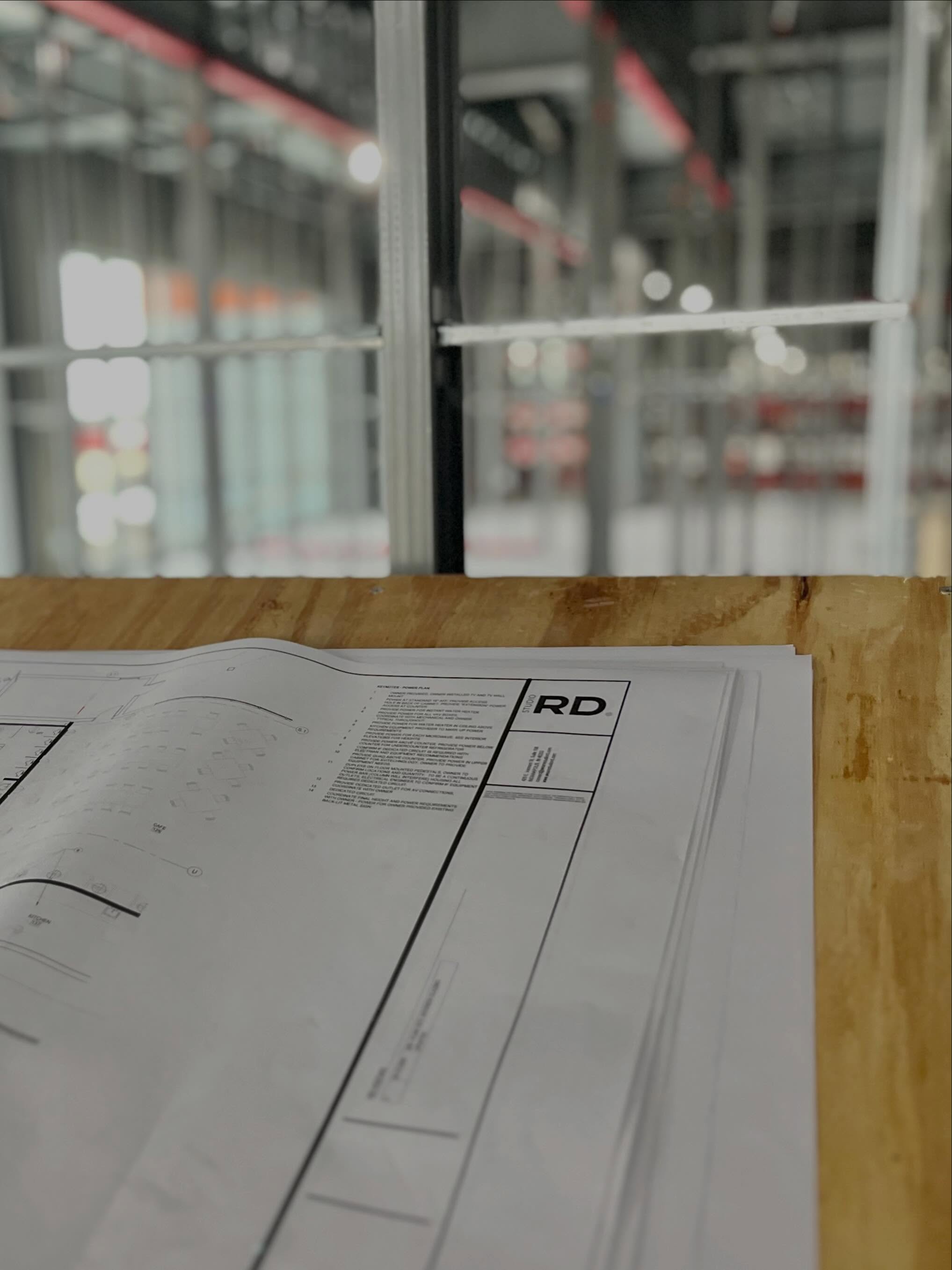 One of our favorite views…construction in progress, walls going up and a set of our drawings leading the way!