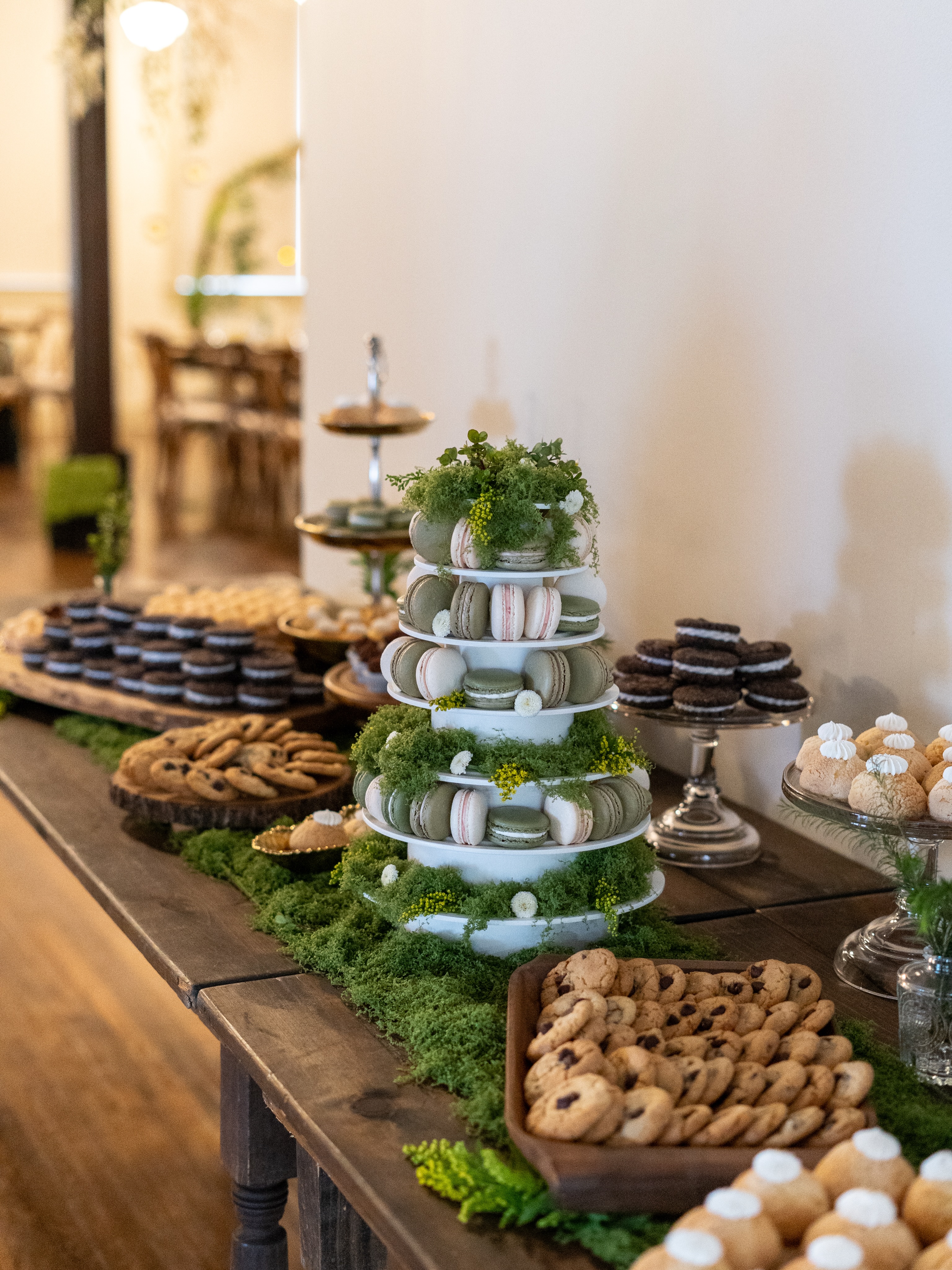 A dessert table full of rustic charm & set against the historic backdrop of the Tampa Fire Fighters Museum🍃 The bride envisioned not only an assortment of desserts but a macaron tower as the centerpiece. 🍪 Table featured Mini Cookies & Cream Cookie Sandwiches, Double Chocolate & Orange Blossom Passion Fruit Cupcakes, Vanilla Bean Cream Puffs, Brown Butter Chocolate Chip Cookies & a variety of macaron flavors. We also provided all of the dishes, florals & rustic decor which completed the couples’ overall vision 🌼