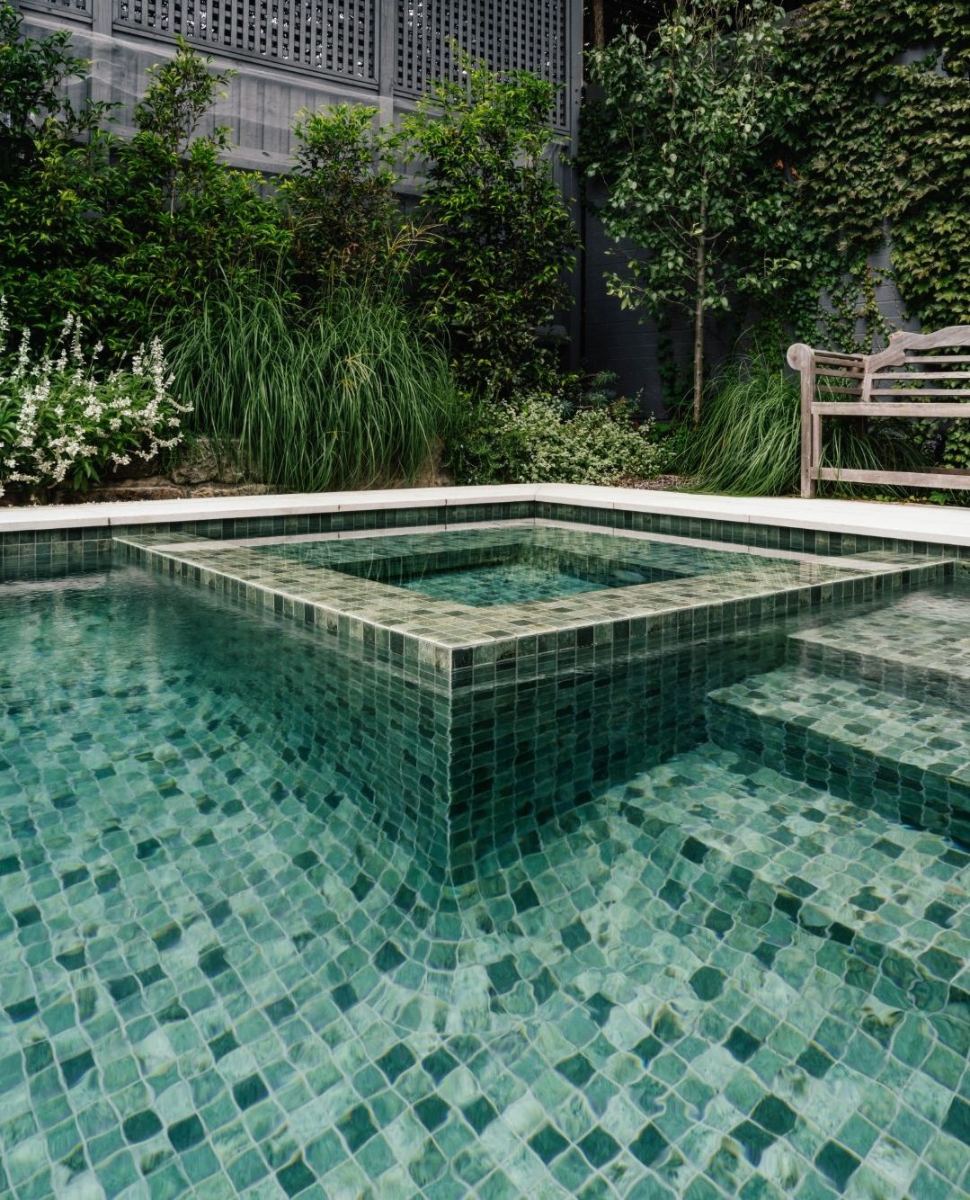 The Sukabumi look, without the Sukabumi maintenance.
Indonesian Sukabumi stone has become one of the most coveted pool finishes in the world. That deep, shifting green that changes with the light and the depth of the water reminiscent of the pools in luxury resorts from Bali to the Maldives.
The problem is Sukabumi is porous, reactive to pool chemicals, and notoriously high maintenance in an Australian climate. These tiles from Artisan Exterior deliver the same visual result without the upkeep and we think they look fabulous!
