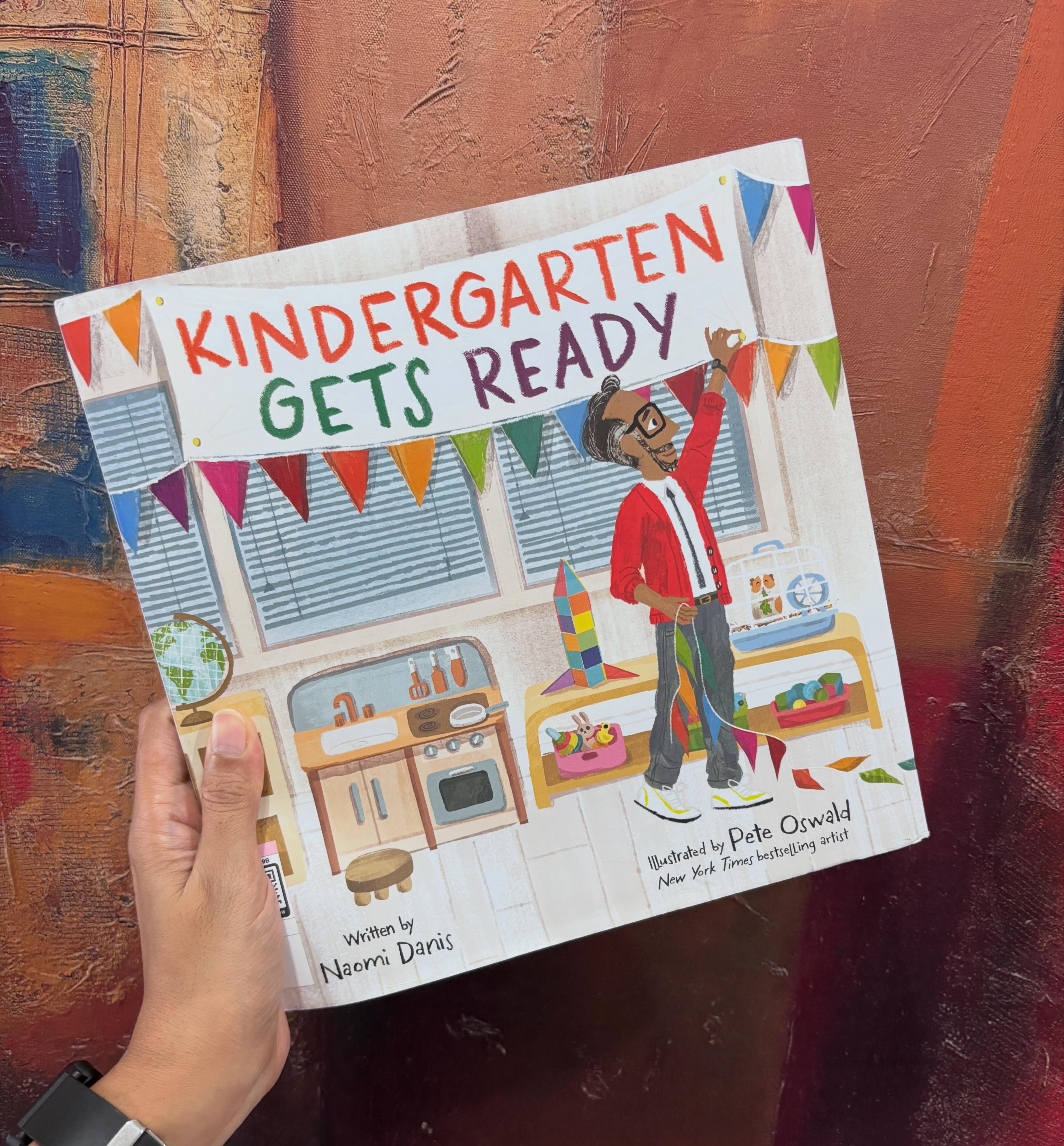 It is waaay too early to talk about back-to-school books, but if you teach Kindergarten and “All Are Welcome” is your staple, it’s perhaps time to shake things up a bit. “Kindergarten Gets Ready” provides a gentle narrative and a soft start to help ease little ones back to school.
Written in a ‘days-of-the-week’ structure (like The Hungry Caterpillar), it focuses on what Mr Bee, the teacher, did to the classroom while the children were away; how the carpet was rolled out, the books were displayed, how the art corner got new supplies and how the classroom got ready for the most important people of all – the children!
My favourite spread? The reading corner with the book-within-a-book illustration for sure!
Go get your copy now so that it arrives well before it’s time to get the classroom ready.
#readlikeawolfeats #picturebook #backtoschool #mitrasuggests