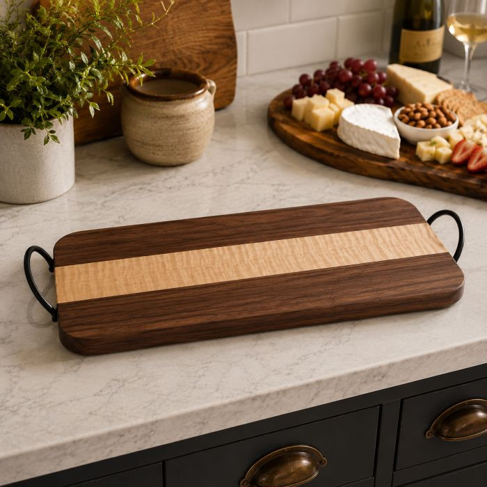 Handcrafted walnut + curly maple, black metal handles, and a food-safe finish — this board turns every spread into a statement. Made to order in Ontario. Link in Bio #CharcuterieBoard #HandmadeHome #WalnutAndMaple #EntertainingEssentials #MadeInCanada #HostessGift