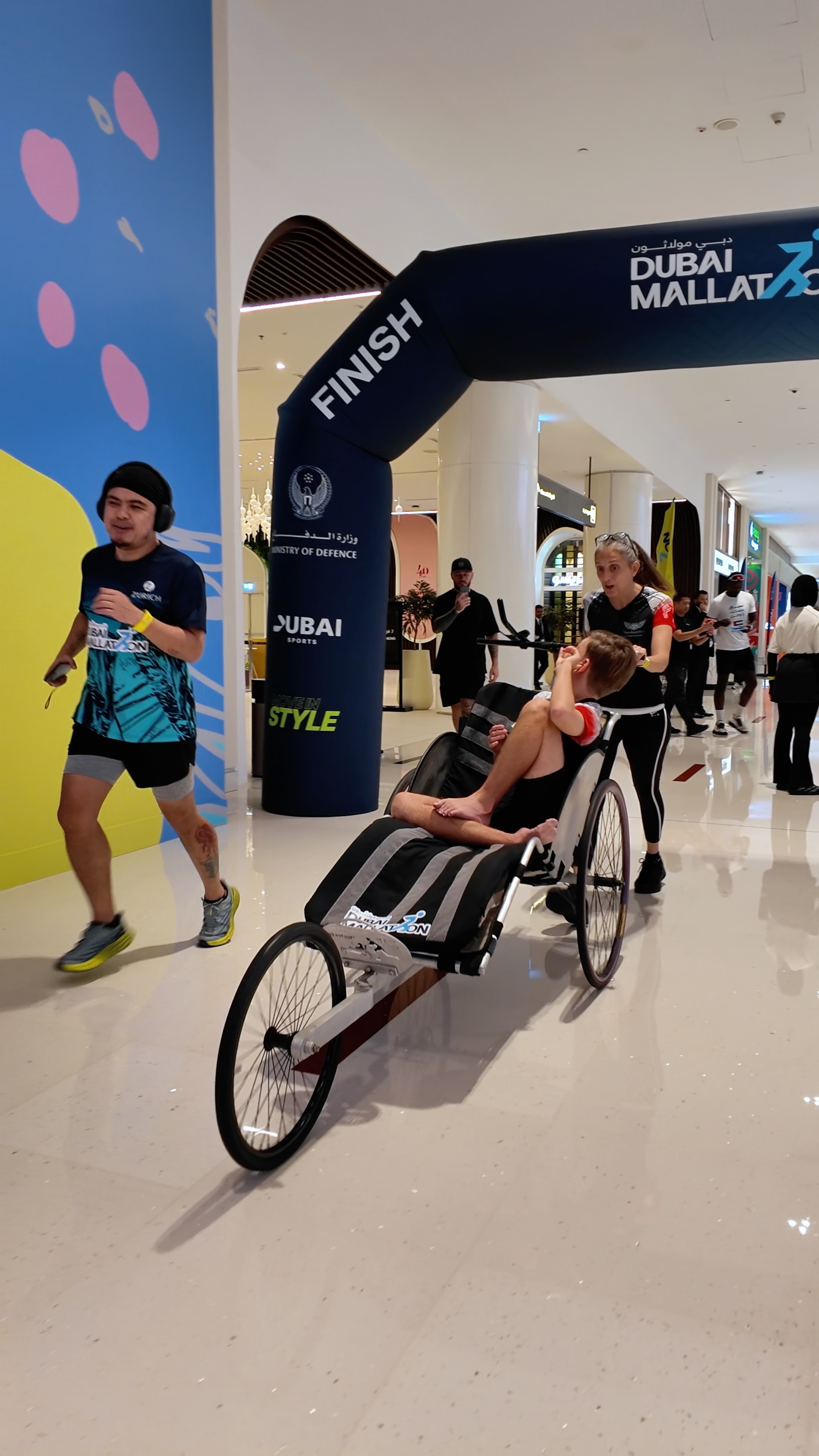 DUBAI MALLATHON 2026 🏃♀️🏃♂️♿💙
This morning summed up so much of what Team AngelWolf is all about.
Dubai Mallathon is back for 2026 - bigger and better than ever.
Six malls.
Every day from 6 –10am.
A chance for the community to walk, run, roll, move, connect, and belong.
For Day 1, we chose Dubai Mall.
As we drove into the car park, Rio instantly knew where he was.
There is only one reason we arrive at a mall this early with his running chair.
With the biggest smile, he shouted:
“Yay! So exciting!”
It honestly felt like coming home.
A community reunion.
So many familiar faces.
So many new friends to meet.
So many people calling out:
“Hi Rio!”
As we started our laps, something happened that perfectly captures why we call Dubai, UAE home.
We heard a group of fast runners approaching behind us.
Then we heard them shouting:
“RIO! RIO! RIO!”
Some were friends.
Some we’d never met before.
The next thing I knew, they had swept Rio away and disappeared into the distance, running together.
As a mother, that should probably have terrified me.
But it didn’t.
Because I knew Rio was safe.
I knew he was loved.
I knew he was exactly where he wanted to be.
Laughing.
Going fast.
Making new friends.
He wasn’t being looked after by strangers.
He was being embraced by community.
That moment reminded me what true inclusion looks like.
Not programmes.
Not policies.
Not words.
People naturally making space for one another and ensuring nobody is left out.
Thank you to everyone who ran with Rio today, pushed his chair, stopped to say hello, and helped make his morning so special.
Thank you @warayindubai for joining the family today.
And thank you to His Highness Sheikh Hamdan bin Mohammed bin Rashid Al Maktoum @faz3 for creating an initiative that brings community together through movement, wellbeing, and belonging.
It feels so good to be back.
Welcome back, Dubai Mallathon 2026. 💙🇦🇪
@dubaimallathon @mydubaicommunities @mydubai @dubaimall @emaardubai
#DubaiMallathon #MyDubai #TeamAngelWolf #InclusiveImpactivity