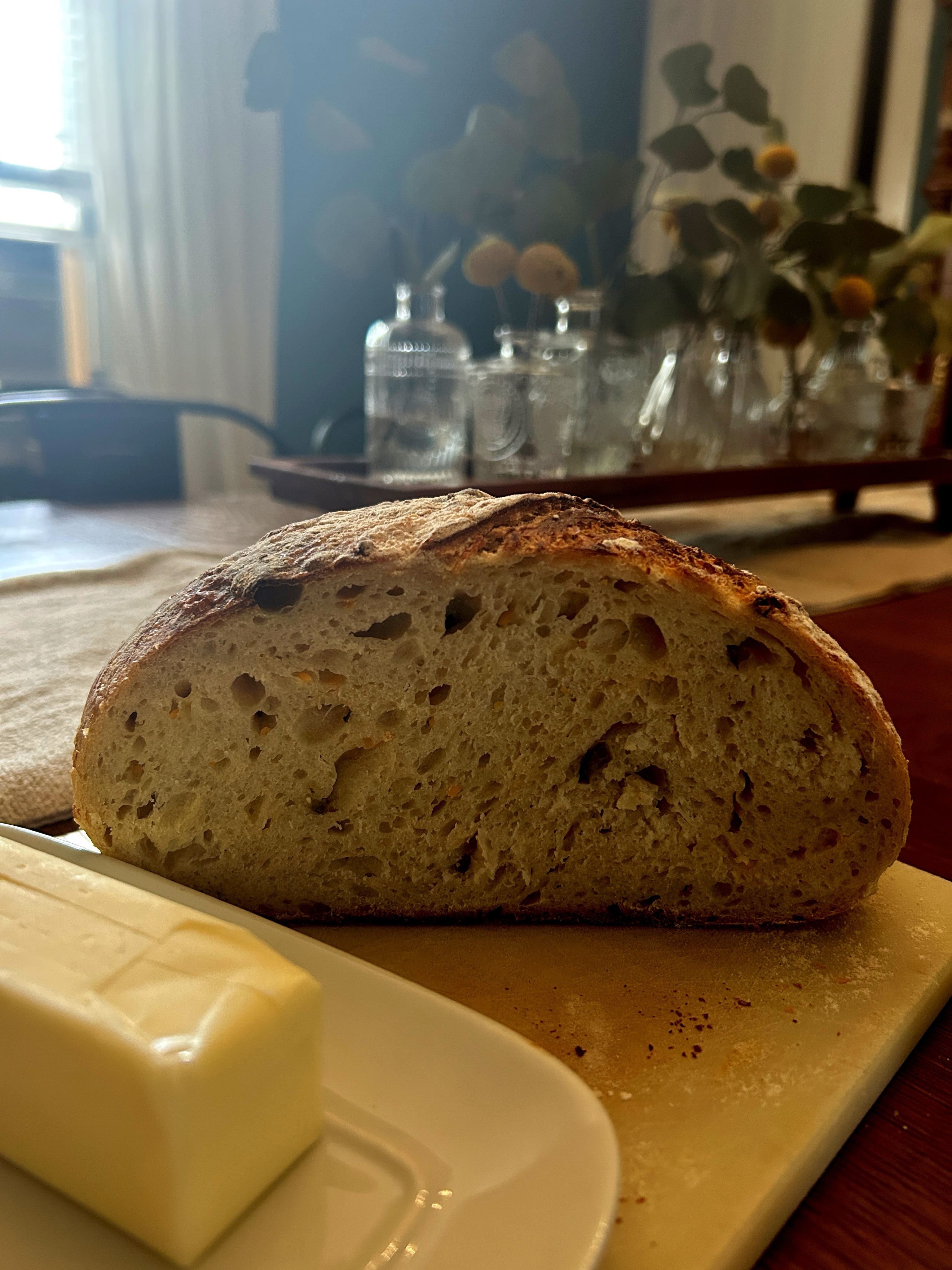 When one has the darkest of dark days, one is sometimes best ministered to not by spiritual platitudes or a “peace that passes all understanding,” but instead by a sister who bakes you jalapeño cheddar sourdough. And you eat it with butter and you eat it with mayo and tomato, and like the Eucharist, maybe this is God’s exact location.