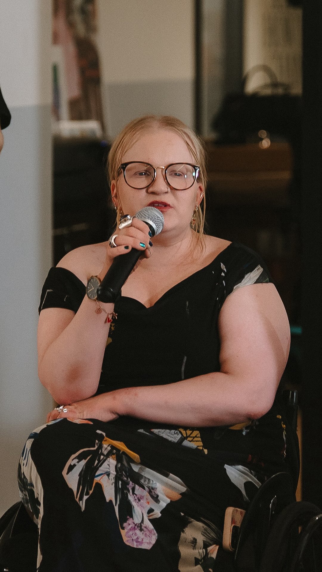 Inclusion is not the final destination. It is the starting point.
When we stop debating whether disabled people should be in the room and start working with them inside the room, that is when creativity explodes.
Give us a chance and you will see what happens.
Made possible by: Future Being @microsoft @hilfsgemeinschaftderblinden @hiddendisabilitiessunflower @accurate.uk @beplayapp @connievandarakis @thedaitaniverse @cmtwegotthis @openstylelab @parsonsschoolofdesign @fitnyc @positiveexposure @givebeautywings
#InclusionIsBaseline #DisabilityDesign #InclusiveFashion #FashionRevolution #NothingAboutUsWithoutUs
AltText:
A woman wearing glasses and a black patterned dress speaks into a handheld microphone while seated in a wheelchair. She appears focused and engaged as she shares her perspective during a panel discussion, contributing to an open and inclusive conversation.