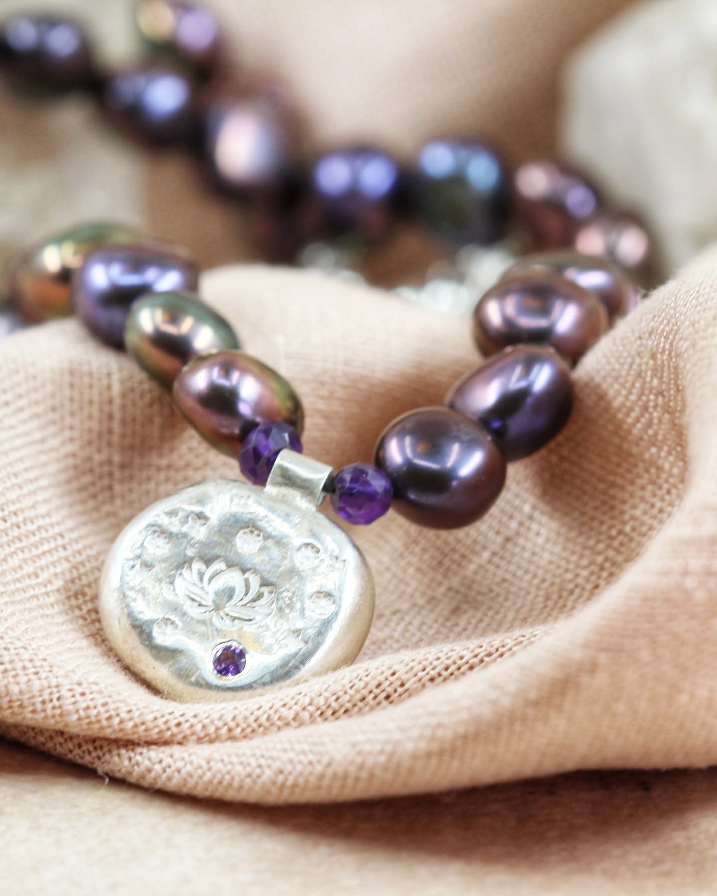 Rune Necklace V ✨
This one feels dark, grounding, and quietly powerful 🖤
Hand knotted on black silk and strung with luminous black peacock freshwater pearls and amethyst, this one-of-a-kind Rune Necklace centres around a Lotus Rune set with glowing amethyst.
A talisman inspired by transformation, resilience, and trusting your own evolution ✨
🪷 Lotus — growth, spiritual awakening & rising through challenge
💜 Amethyst — intuition, calm & spiritual clarity
🖤 Black Peacock Pearls — wisdom, emotional depth & quiet strength
Finished in sterling silver with an adjustable extender chain for layering.
Honestly… this piece feels like armour for periods of growth and change 🌙✨
#RuneNecklace #LotusJewellery #MysticMenace #HandmadeJewelleryUK #JewelleryWithMeaning