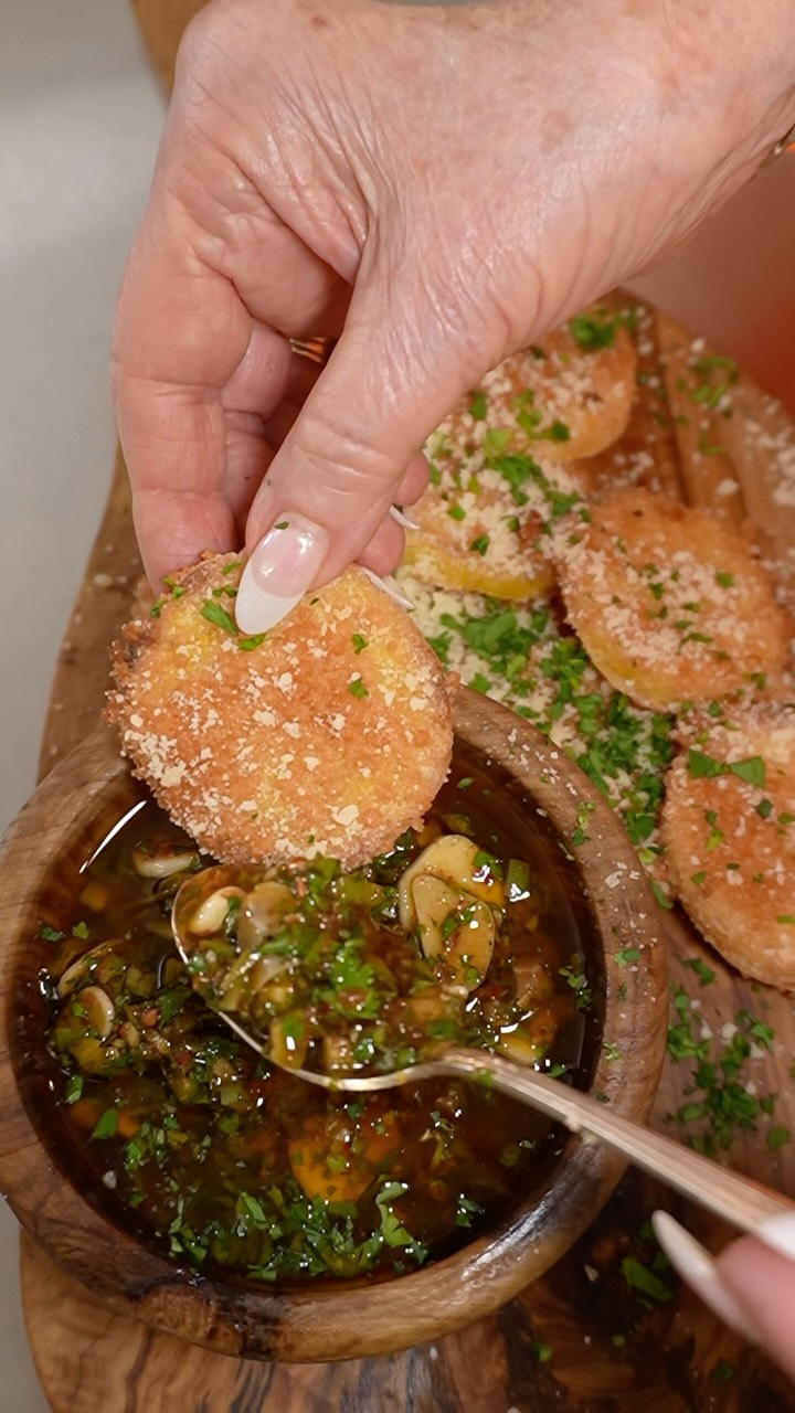 A good dipping oil invites people to slow down. To tear off a piece of bread. To scoop up a crisp piece of polenta. To stand around the kitchen island saying, “Just one more bite.”
1 prepared tube of polenta
Extra virgin olive oil
2 to 3 tablespoons cornstarch
Parmigiano Reggiano, finely grated
Fresh cracked black pepper
Preheat oven to 425°F. Slice the polenta into thin rounds, about ¼-inch thick or slightly thinner. Pat the slices dry with paper towels to remove excess moisture.
Lightly dust both sides of each slice with cornstarch, shaking off any excess. Dip in olive oil. Season with salt and pepper. Line a baking sheet with parchment paper. Sprinkle a light layer of finely grated Parmigiano Reggiano directly onto the polenta.
Bake for 20 to 25 minutes, carefully flipping halfway through, until golden brown and crisp around the edges. Return to the oven if needed until the Parmesan forms a beautiful golden crust and the polenta is crisp on the outside.
The Goal: Crisp edges. Creamy center. Golden Parmesan crust. Scoopable structure.
Spanish Dipping Oil:
1/2 cup mixed olives, chopped
4 cloves garlic, thinly sliced
¼ cup fresh cilantro, chopped
¼ cup fresh parsley, chopped
2 tablespoons jalapeno, finely minced
1 teaspoon silk chili powder
1 teaspoon smoked paprika
Juice of 1 lime
Zest of 1 orange
2 tablespoons sherry vinegar
2 tablespoons hot honey
⅓ cup Spanish extra virgin olive oil
Kosher salt, to taste
Freshly cracked black pepper, to taste
Pinch of ground cumin
Combine the olives, garlic, cilantro, parsley, and jalapeño in a mixing bowl. Add the silk chili powder, smoked paprika, lime juice, orange zest, sherry vinegar, hot honey, and olive oil. Season with salt, pepper, and a whisper of cumin. Stir gently to combine.
Allow the mixture to sit for 15 to 20 minutes before serving so the flavors can mingle.
Serve spooned generously over or alongside warm Baked Polenta Crisps. Enjoy!
#appetizer #dippingsauce #polenta #summersnack #recipe