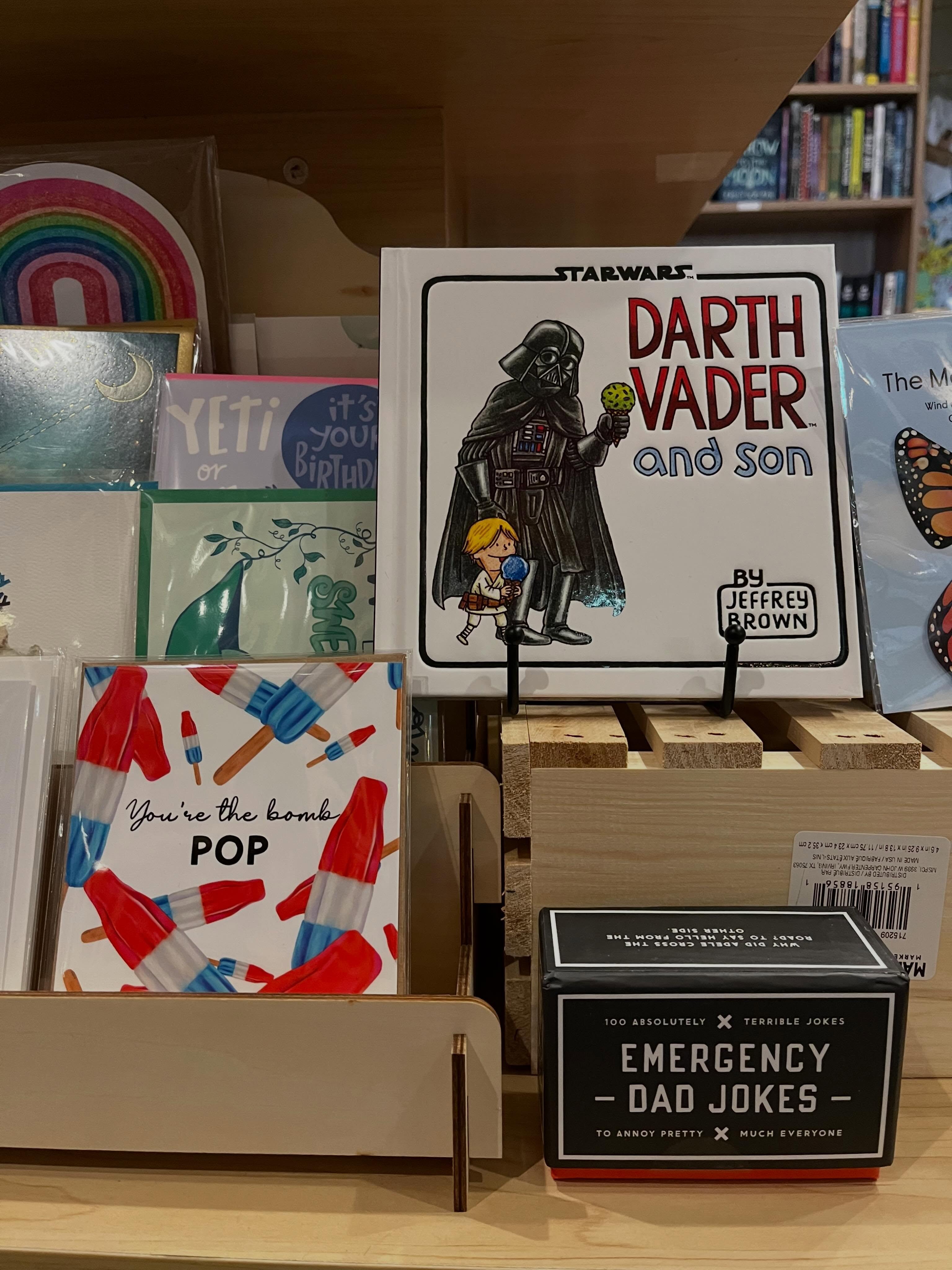 Just a little reminder that Father’s Day is tomorrow!
Whether he’s the bedtime story reader, the comic book collector, the dad-joke champion, or the one who always says “just one more chapter,” we’ve got books for dads, grandpas, uncles, and all the grown-ups who share stories with the kids they love.
Stop by this week for picture books, graphic novels, epic tales, and plenty of ideas for every kind of reader.