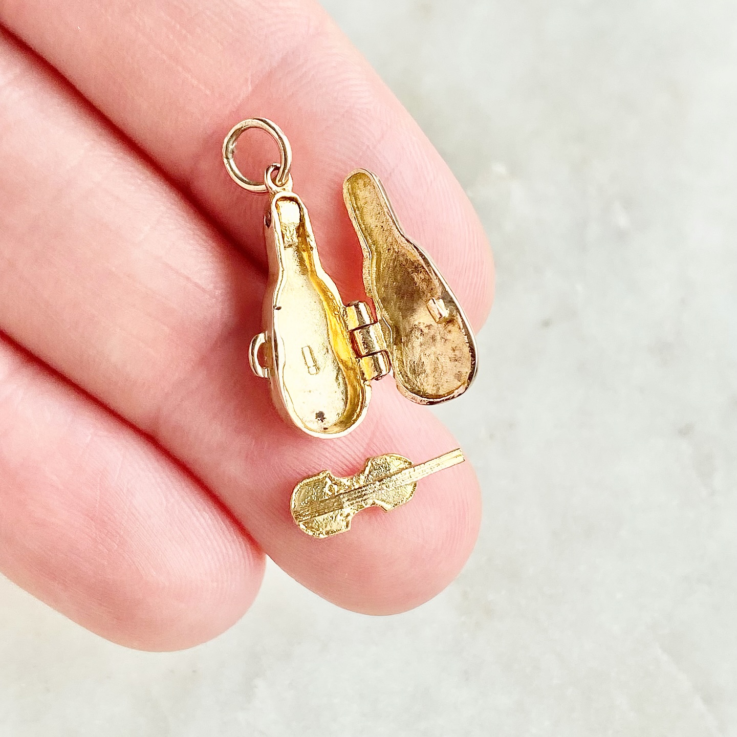 🎻 Could this be the tiniest golden violin?! ✨💛 This sweet charm is crafted in 9ct gold, even the case is wonderfully detailed throughout (and complete with a little handle 🥹) and it opens to reveal a gold violin inside 😍 We think it was once attached to the case but it is now fully removable as if it’s ready to play 🎶 Both the outside and inside of the case has British hallmarks, the inside for 9ct gold and the outside for 9ct gold, Birmingham and the date letter for 1965 💛 You can find the full details over on our website #kategoldcharms #violin #violinlove #openingcharms #vintagecharms