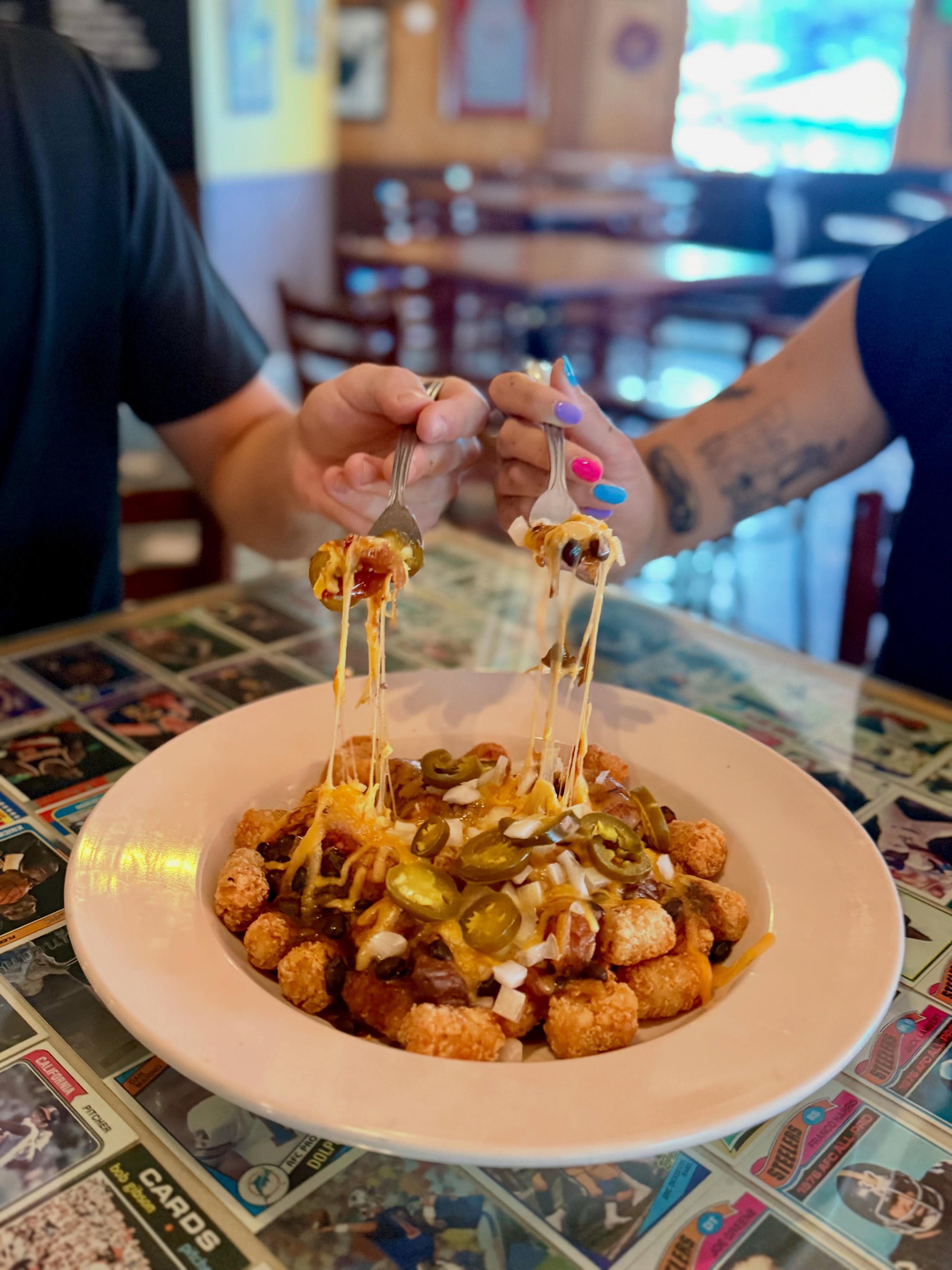 Sharing is caring as seen in our photo. However, we have great respect for those who dive into Chili Tots with their own two forks!
-
Weekly Specials: June 23 - June 27
-
Appetizer Special: Chili Tots
1lb of golden fried tartar tots topped with steak chili, cheddar cheese, diced yellow onions, and jalapenos served with a side of sour cream
-
Lunch Special: Meatloaf Sandwich
House made meatloaf with cheddar cheese on toasted Texas bread. Served with a side of ale ketchup
-
Daily Soup: Steak Chili topped with cheddar cheese and green onions
-
Specialty Burger: Huckleberry Burger
Grilled beef patty topped with goat cheese, bacon and huckleberry BBQ with tomatoes, red onions, and arugula on a toasted bun
-
Birch Salmon: Grilled and topped with a orange thyme BBQ
