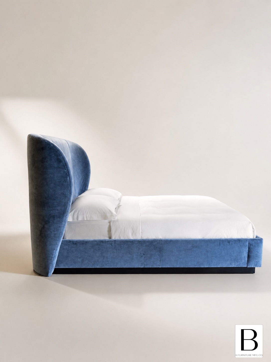 A statement in modern luxury, the Sculpted Wing Bed features an elegantly curved, wing-inspired headboard upholstered in rich velvet for a soft, tailored look. Its clean-lined frame and dramatic silhouette create a striking focal point, while the fully upholstered design adds warmth and sophistication. Perfect for contemporary interiors, this bed balances bold artistry with comfort.
#furniture #furnituremfg #customfurniture #upholstery #customupholstery