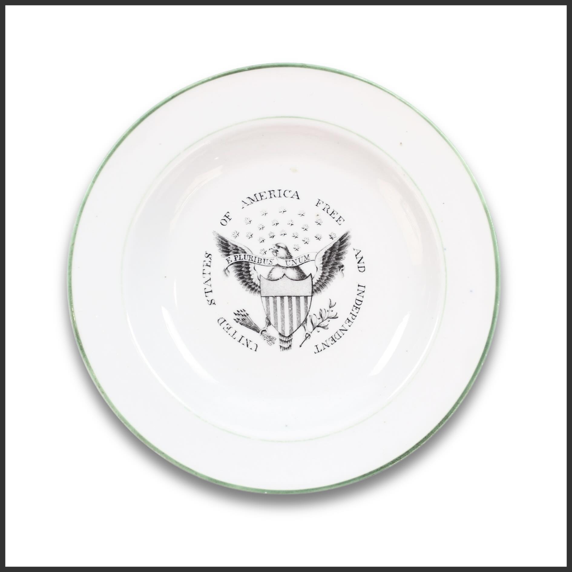 Now featured in Independence Unfolded: America at 250, available through July 17.
A Staffordshire plate transfer-printed with an American eagle bearing shield, olive branch, and arrows, accompanied by the inscription “United States of America — Free and Independent.” Produced in England for export to the American market, the design presents a bold expression of national sovereignty through one of the most enduring iconographic formulas of the early republic.
Issued in the decades following the War of 1812, the plate reflects the continued popularity of patriotic ceramics celebrating American independence and national identity. Objects of this kind demonstrate the enduring appeal of Federal iconography well into the nineteenth century, translating the symbolism of the young republic into everyday domestic life.
View the complete catalog via the link in our bio.
#Gallery76Americana #Staffordshire #AmericanEagle #Americana #America250