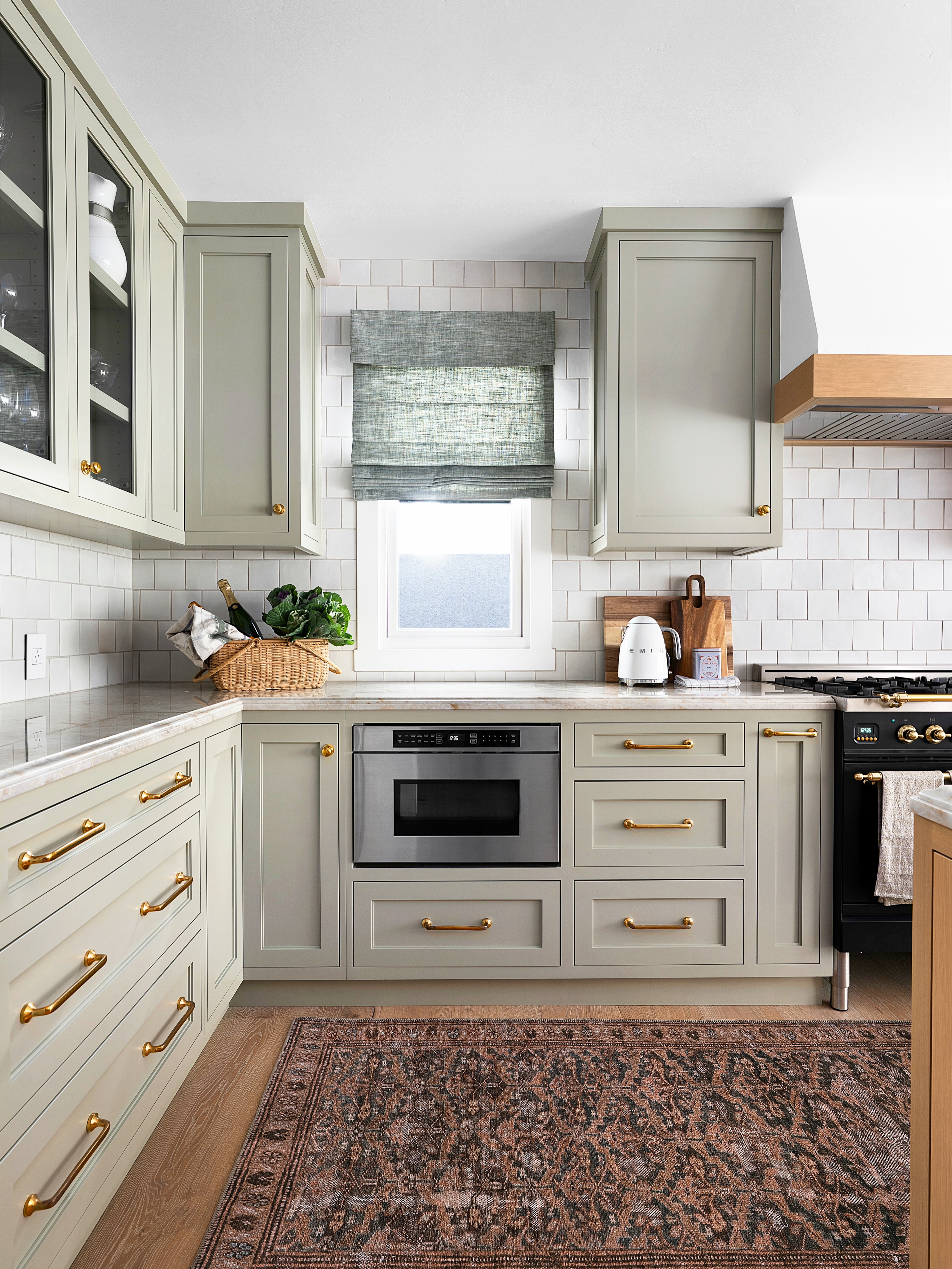 This one brings so much warmth and character. We took a builder grade kitchen and worked closely with our client to give it a custom upgrade! Quality matters. New maple cabinets with a rift white oak island, unlacquered brass hardware and plumbing, stacked ogee edge countertop and a handmade glazed backsplash all to compliment her @ilveranges