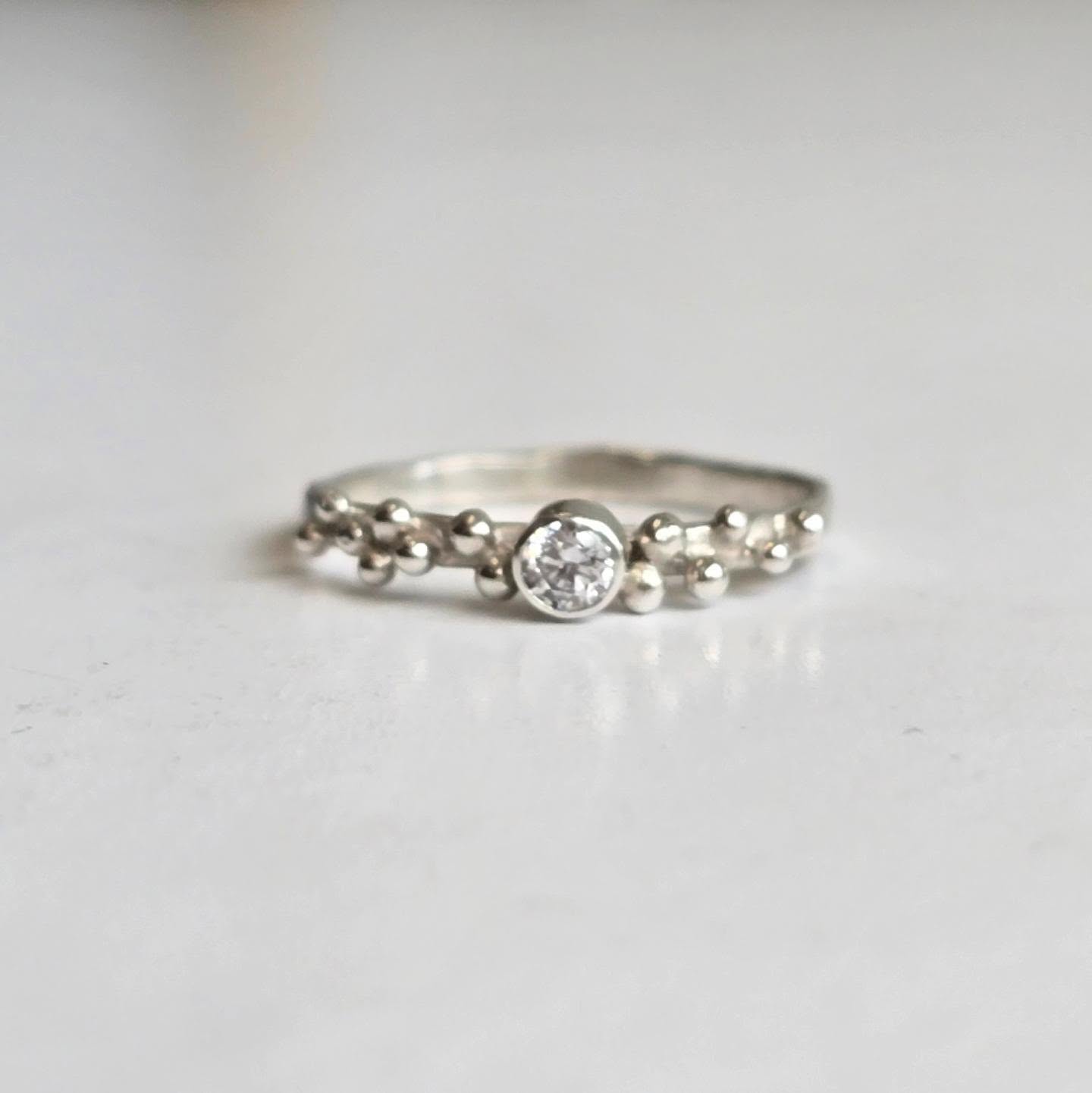 ✨ She said yes. ✨
This Sea Spray ring was created as a one-of-a-kind engagement ring, featuring a sparkling moissanite.
Inspired by the sea and the gentle spray of the waves, it's perfect for someone looking for an engagement ring that's a little different from the traditional styles. I've had the pleasure of creating several more Sea Spray engagement rings in gold, each handcrafted and unique.
If you're looking for a bespoke engagement ring that's as unique as your love, I'd love to help.
This ring also looks amazing in all the birthstones that I offer too 💍
