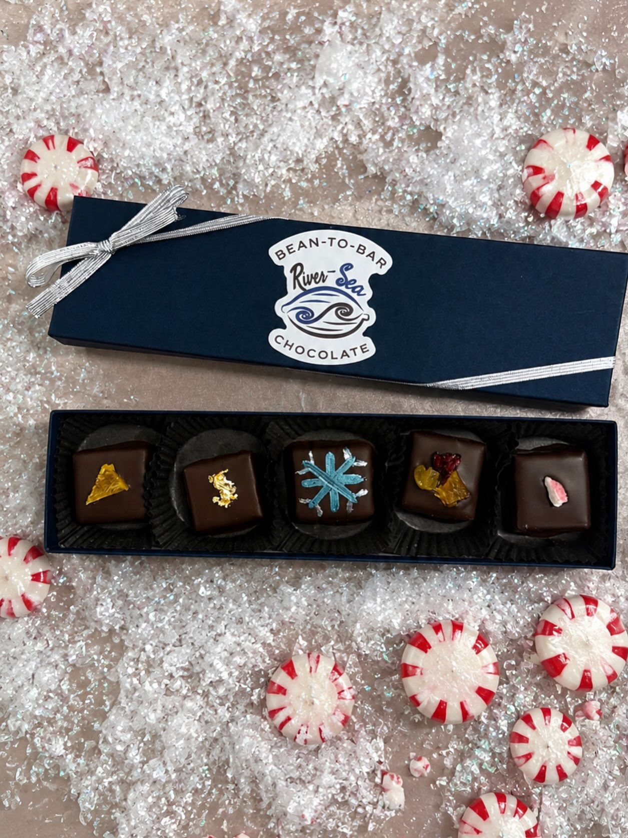 Merry Chocomas in July! The heat has us dreaming of wintery days with snow and ice (and hot chocolate, of course!) While we can’t time-travel, we’re evoking memories of those colder days with 5 of our most popular holiday-time truffle flavors:
Blood Orange Spice - flavored with blood orange and a masala spice blend, topped with candied orange
Eggnog - spiked with white rum and accented with nutmeg, topped with edible gold leaf
Gingerbread - spiced with lebkuchengewürz, a German gingerbread spice blend, and hand-painted with snowflakes
Fruitcake - warming spice blend topped with dried cranberries, golden raisins, and oranges
Peppermint - topped with crushed soft peppermint candies
These truffles will be available until we run out, so grab some while you can!
#craftchocolate #christmasinjuly #beantobar