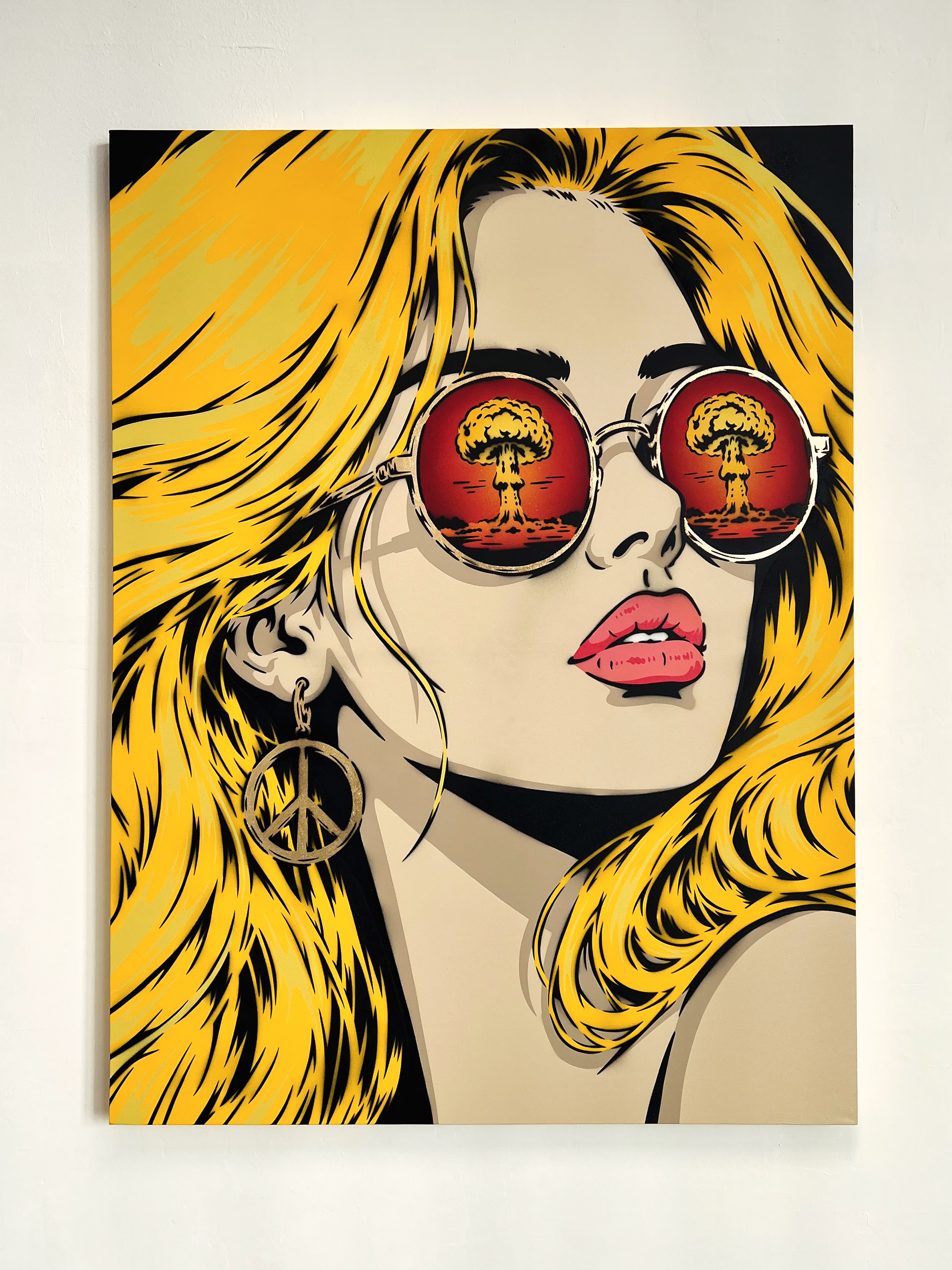 Peace ☮︎ Not War
48” x 36” Spray Paint and Gold Leaf on Canvas
All she wants to see is peace.
She carries it with her, wears it proudly and chooses to believe in it. But wherever she turns, another mushroom cloud appears in the reflection. Another conflict. Another tragedy. Another reminder of how difficult it is to move forward when the world keeps pulling us backwards.
This painting is about holding onto hope, even when war seems determined to follow us wherever we look. The peace symbol isn’t there because we’ve found peace. It’s there because we haven’t stopped searching for it.