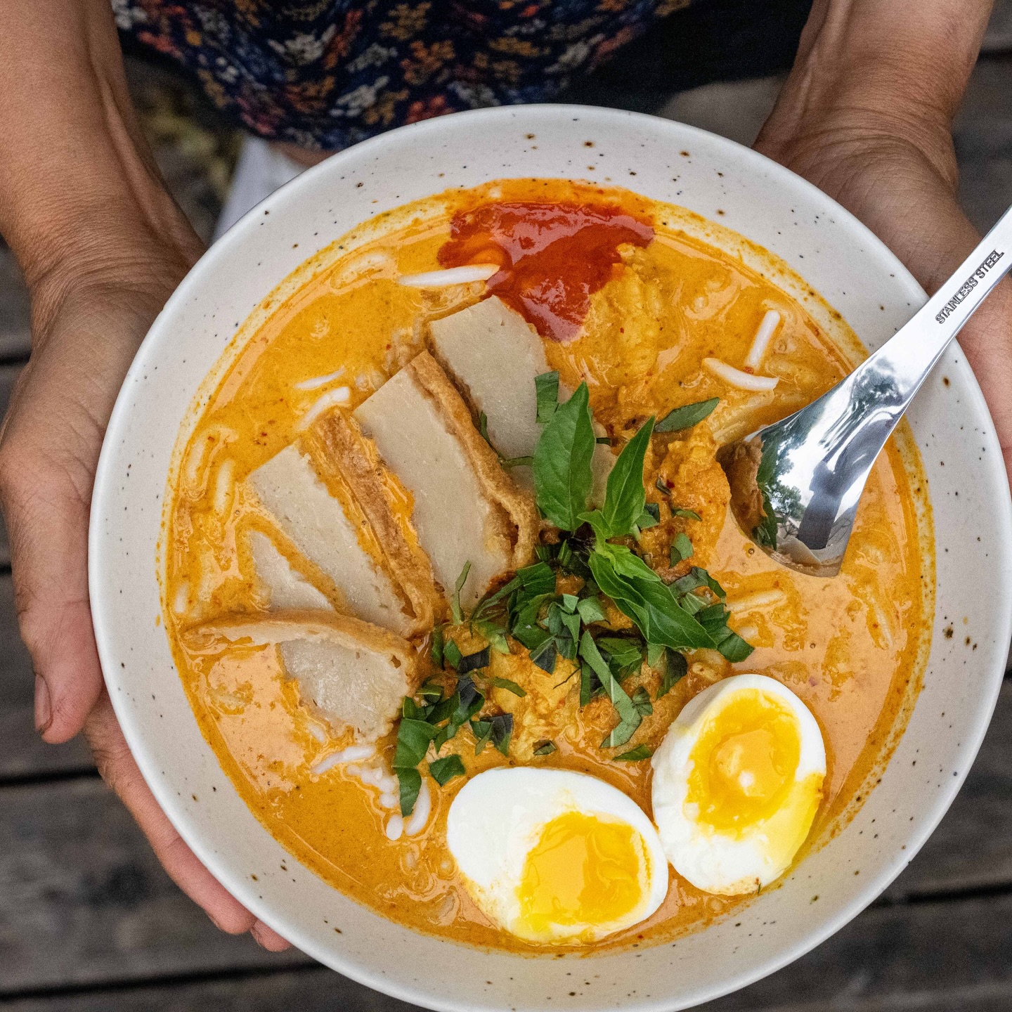 Rainy outside, laksa inside. This cozy Singaporean dish features a rich coconut curry broth with fish cakes and shrimp, served 8am-2pm daily (until 3pm on weekends).