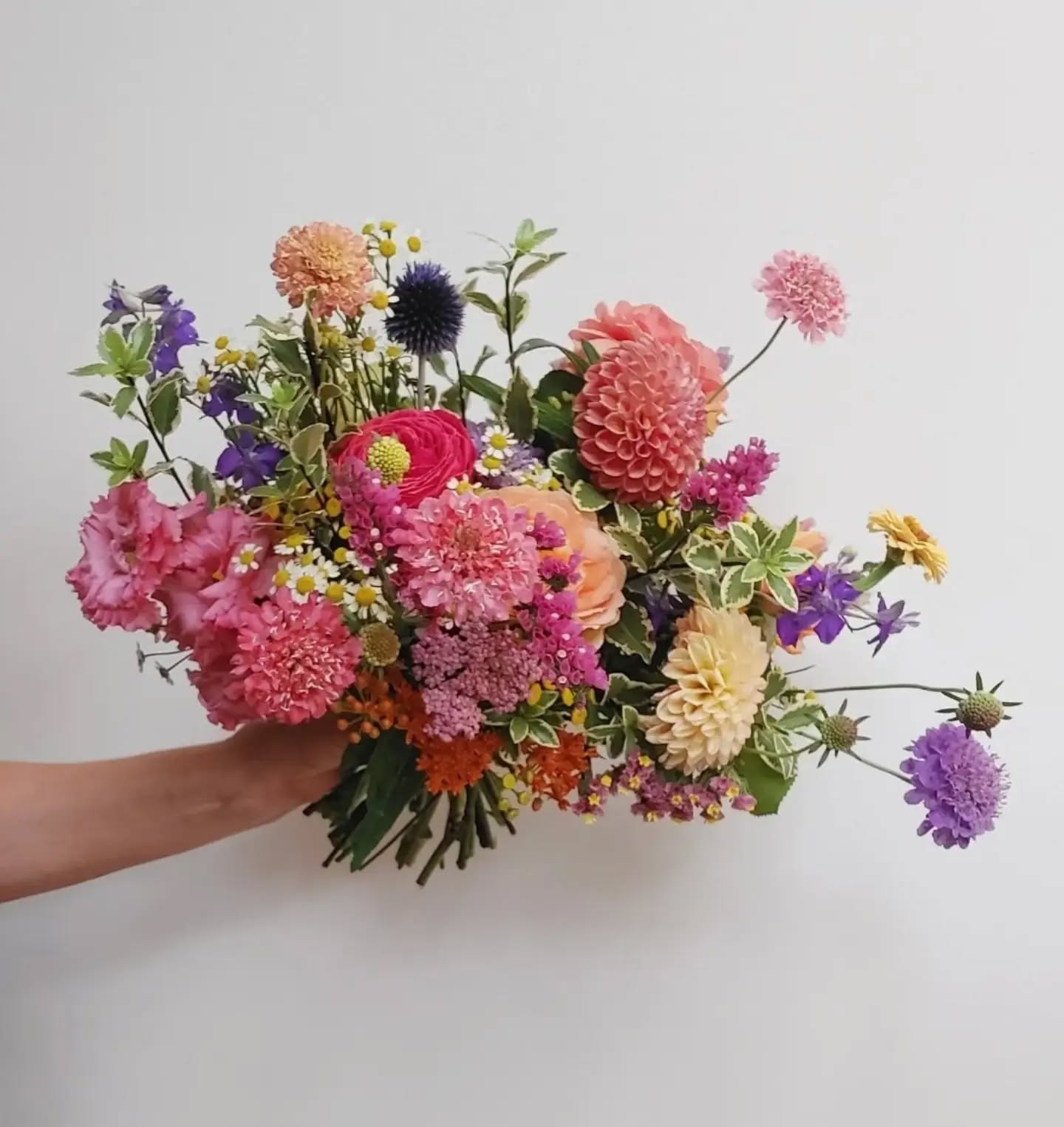 Lizzie's Bouquet.
An abundance of summer colour and texture is celebrated in this beautiful wedding bouquet. I can't decide which one is my favourite. I am split between the peachy scabiosa and the equally peachy zinnia!
wedding flowers / London florist / summer wedding