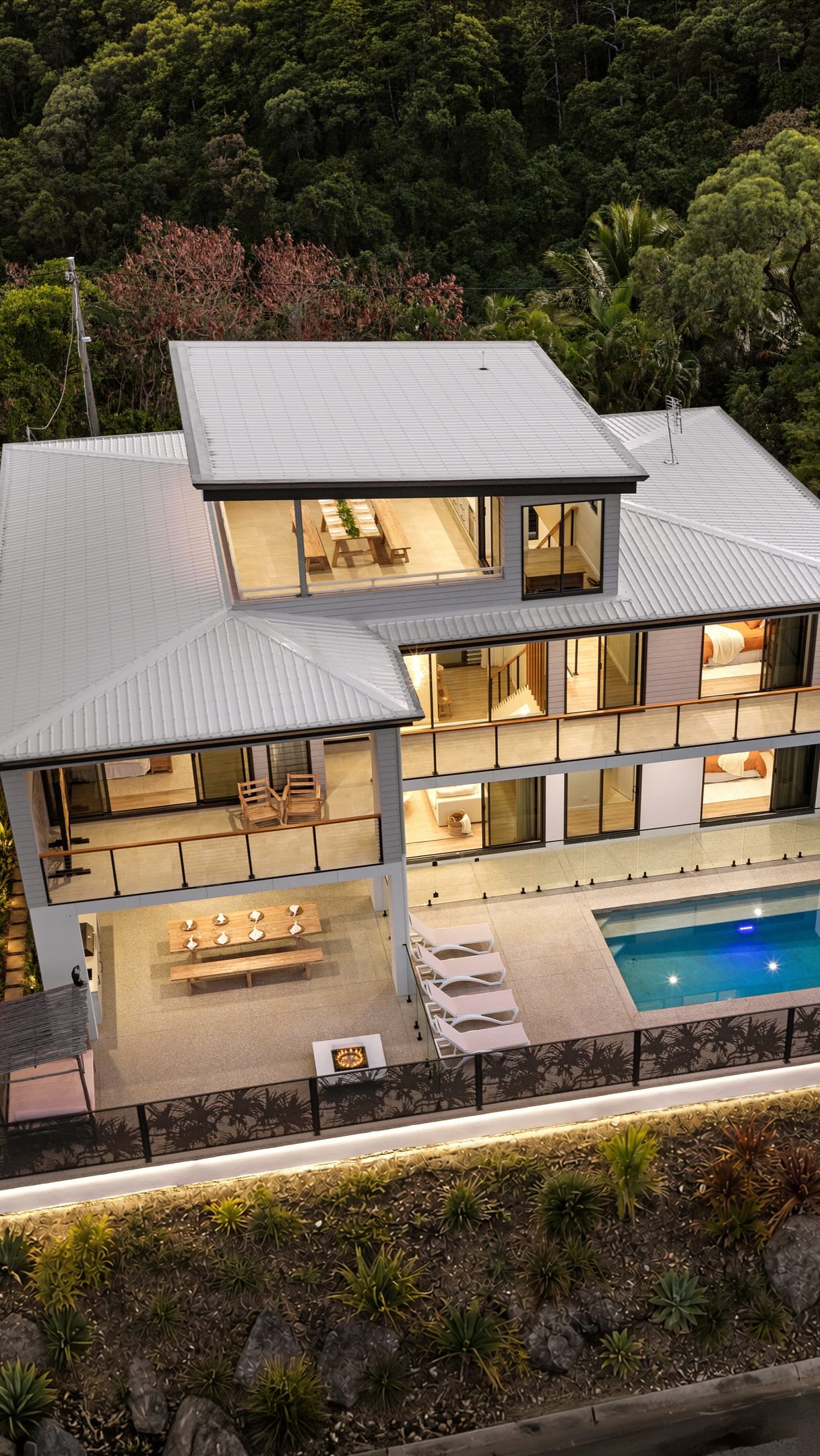 Now essentially completed we’re pleased to share the amazing results of our owner builder client, Ashley Stansfield of @proficient_concreting
We thank Ashley for trusting us with the building design to conceive a coastal private holiday entertainer that makes the most of his property’s stunning views and Goldilocks north-eastern aspect.
We managed to provide ocean views to the:
- Living, Dining and Kitchen
- Pool and Alfresco
- Guest bedroom/office
- Master bedroom & Ensuite
- Second bedroom & Study
- Mezzanine & Sitting room
- Rooftop Lobby and Terrace
Shute Harbour views are also seen from the roof top terrace which we received council approval via a code assessable DA avoiding any neighbourhood objections.
All that is left to do now is install the perforated window screens to the Main Street facade (as seen in the photoshopped still images)
We’re thrilled with the result and thanks to the whole project team for contributing to the outcome.
Special mentions to:
Photographer @brookemilesphotography
Town planner @mcpeaketown
#moderntropicalhouse #coastaldesign #whitsundaysbuilder #ownerbuilder