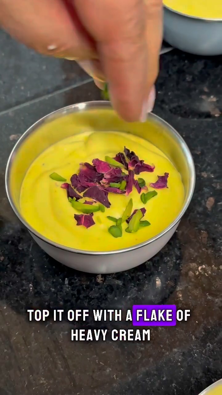 Bastani Sonnati –⬇️⬇️⬇️ RECIPE BELOW- Persian Saffron Ice Cream
Ingredients
Base:
100 ml heavy cream (for freezing)
500 ml heavy cream
8/10 saffron threads
1 can (400 g) sweetened condensed milk
1/2 tbsp rosewater
2 tbsp sahlab powder
½ tsp ground cardamom
20g raw pistachios, chopped
Garnish:
Raw pistachios, chopped
Dried rose petals
Frozen cream shards (from above)
Instructions
Line a flat tray with parchment paper.
Pour 100 ml cream into a thin, even layer.
Freeze for at least 3 hours or until completely solid.
Grind saffron threads in a small mortar and pestle.
Sprinkle the ground saffron over 2 ice cubes in a small bowl.
Let it sit at room temperature to melt and bloom.
In a medium bowl, combine the sweetened condensed milk, bloomed saffron, rosewater, cardamom, and sahlab powder. Stir until smooth and well combined.
In a large bowl, whip 450 ml heavy cream using an electric mixer until stiff peaks form.
Gently fold the saffron-condensed milk mixture into the whipped cream using a spatula. Do not overmix.
Fold in the chopped pistachios.
Remove the frozen cream from the freezer and break it into small shards or flakes.
Gently fold half of the frozen cream pieces into the ice cream mixture.
Transfer the ice cream mixture into individual molds or one large container.
Top with the remaining frozen cream shards, pistachios, and rose petals.
Cover tightly with plastic wrap and freeze for at least 8 hours, or overnight.#persianfood #persiandessert #summervibes☀️ #foodlover #yummy