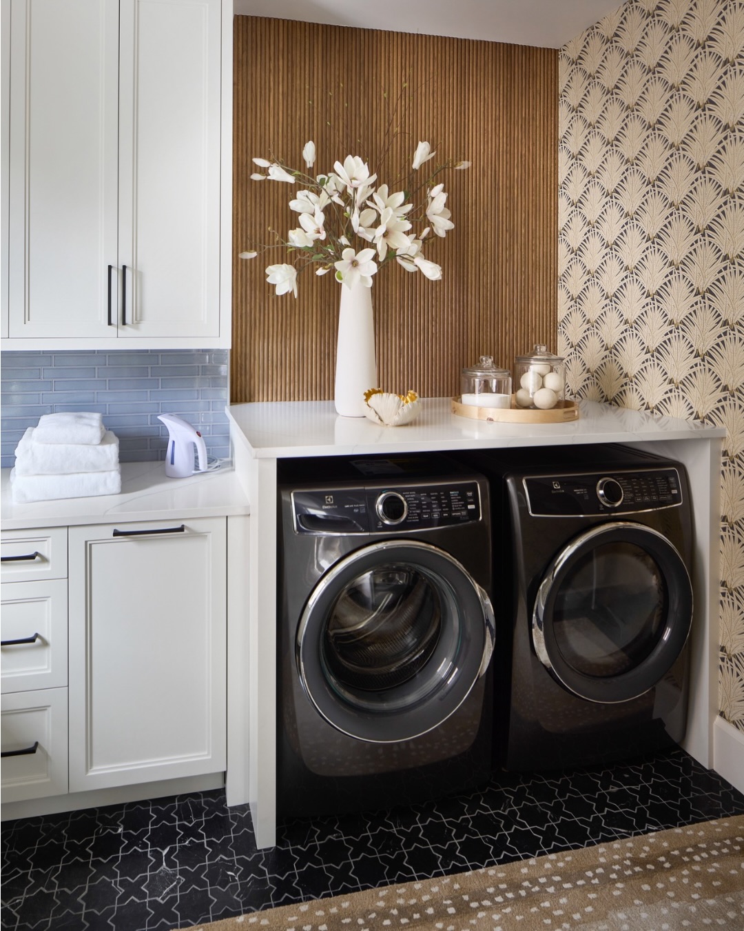 Behind the Design | A Laundry Room Worth Spending Time In
Laundry may never be anyone’s favorite chore, but thoughtful design can make even the most practical spaces feel beautiful.
For this laundry room, we wanted every detail to feel intentional. Crisp white cabinetry provides plenty of concealed storage, while the warm walnut slat wall adds texture and warmth to balance the bright finishes. A bold geometric floor tile grounds the space, and the Art Deco-inspired wallpaper transforms an everyday utility room into one of the most memorable spaces in the home.
We also designed a generous countertop for folding, sorting, and everyday tasks, proving that function and beauty should always go hand in hand.
The best-designed homes don’t stop at the main living spaces. Every room deserves the same level of thought, detail, and craftsmanship.
✨ Because even laundry deserves a little luxury.
What space in your home do you think is most overlooked?
#BehindTheDesign #LaundryRoomDesign #LuxuryLaundryRoom #InteriorDesigner #InteriorDesign WholeHomeDesign LuxuryInteriors CustomHome HomeRemodel InteriorArchitecture ArtDecoInspired WallpaperDesign WalnutDetails FunctionalDesign DesignDetails DenverInteriorDesigner ColoradoInteriorDesigner LuxuryHomeDesign CustomCabinetry EveryDetailMatters
Build by @devexproperties
📷 by @susiephoto
Cabinets by @distinctivecabinetrydesigns
Lighting by @gallerialighting
Tile by @bedrosianstile
Wallpaper by @schumacher_rockymountains
Accessories by @hwhome
Showhouse by @hgcomag